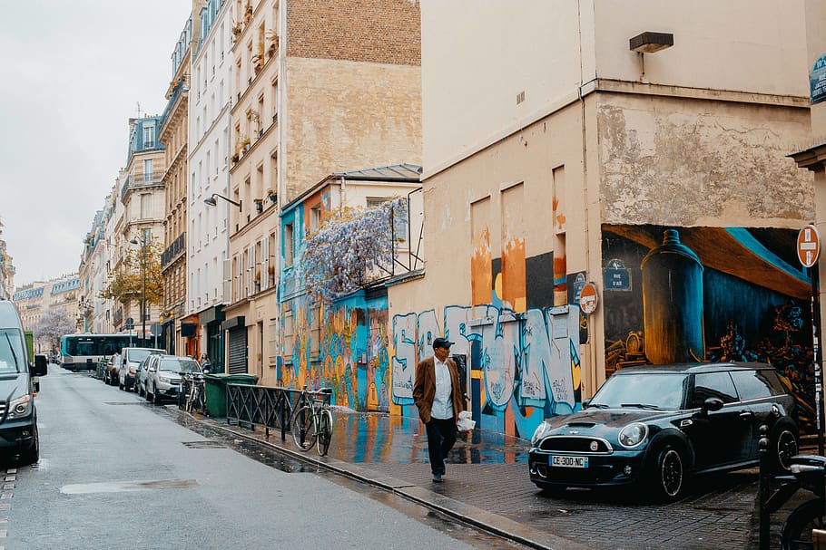 HD Wallpaper Man Walking Near Buildings After The Rain Architecture