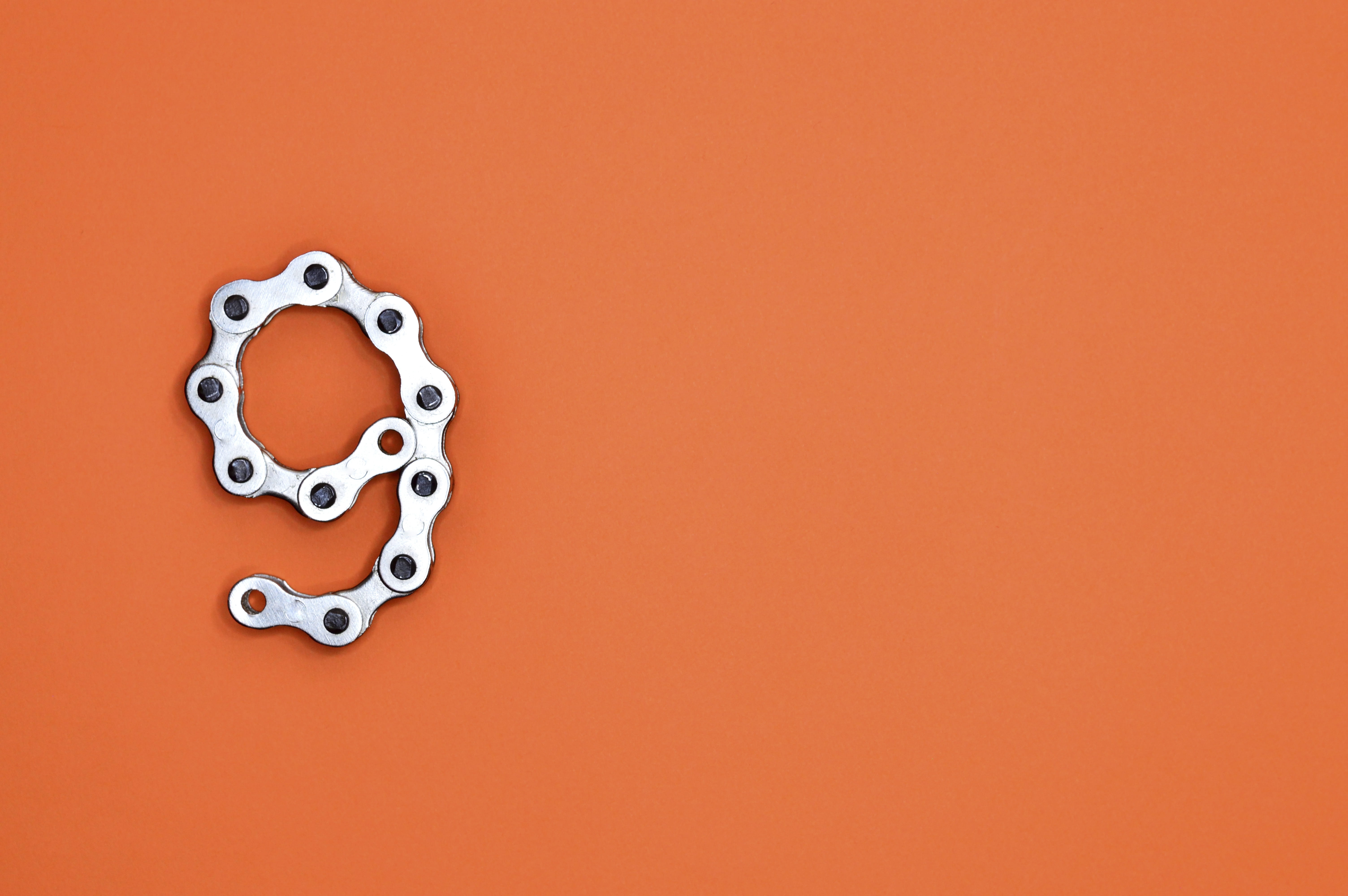 Gray Bicycle Chain on Orange Surface, 9, art, background, chrome
