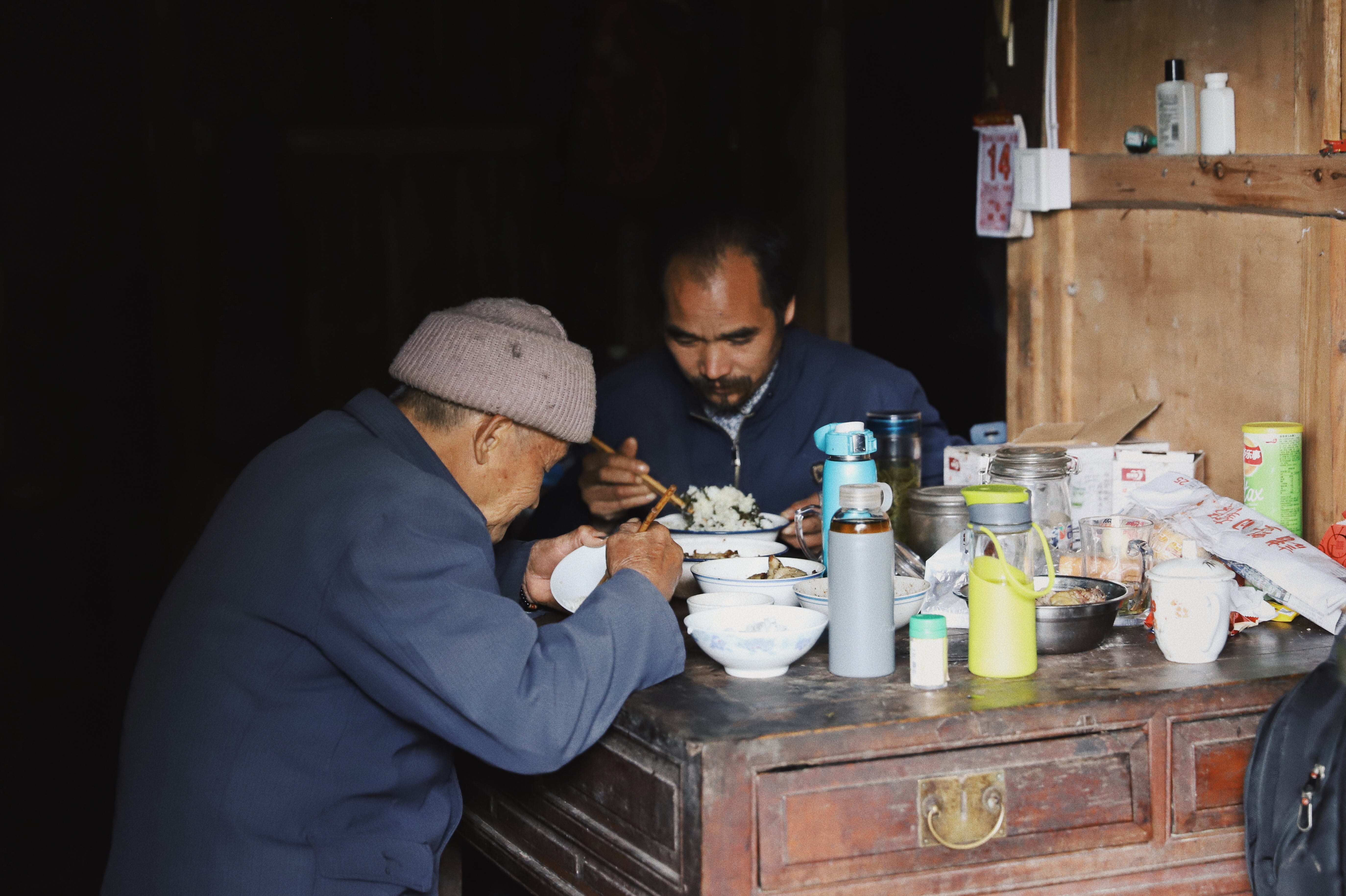 two men eating at the table, human, person, people, bowl, jar