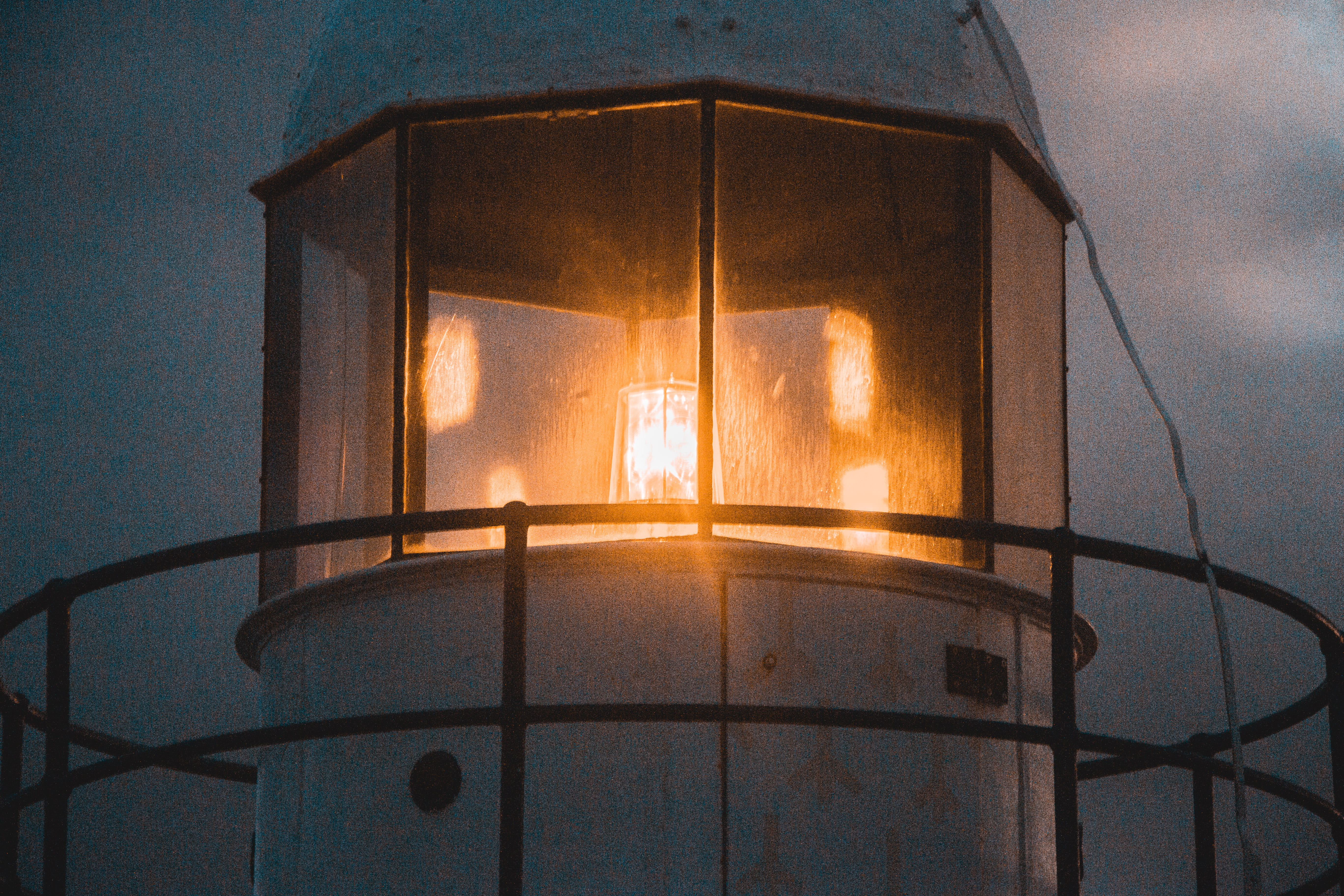 lighted orange lighthouse, sky, window, architecture, no people