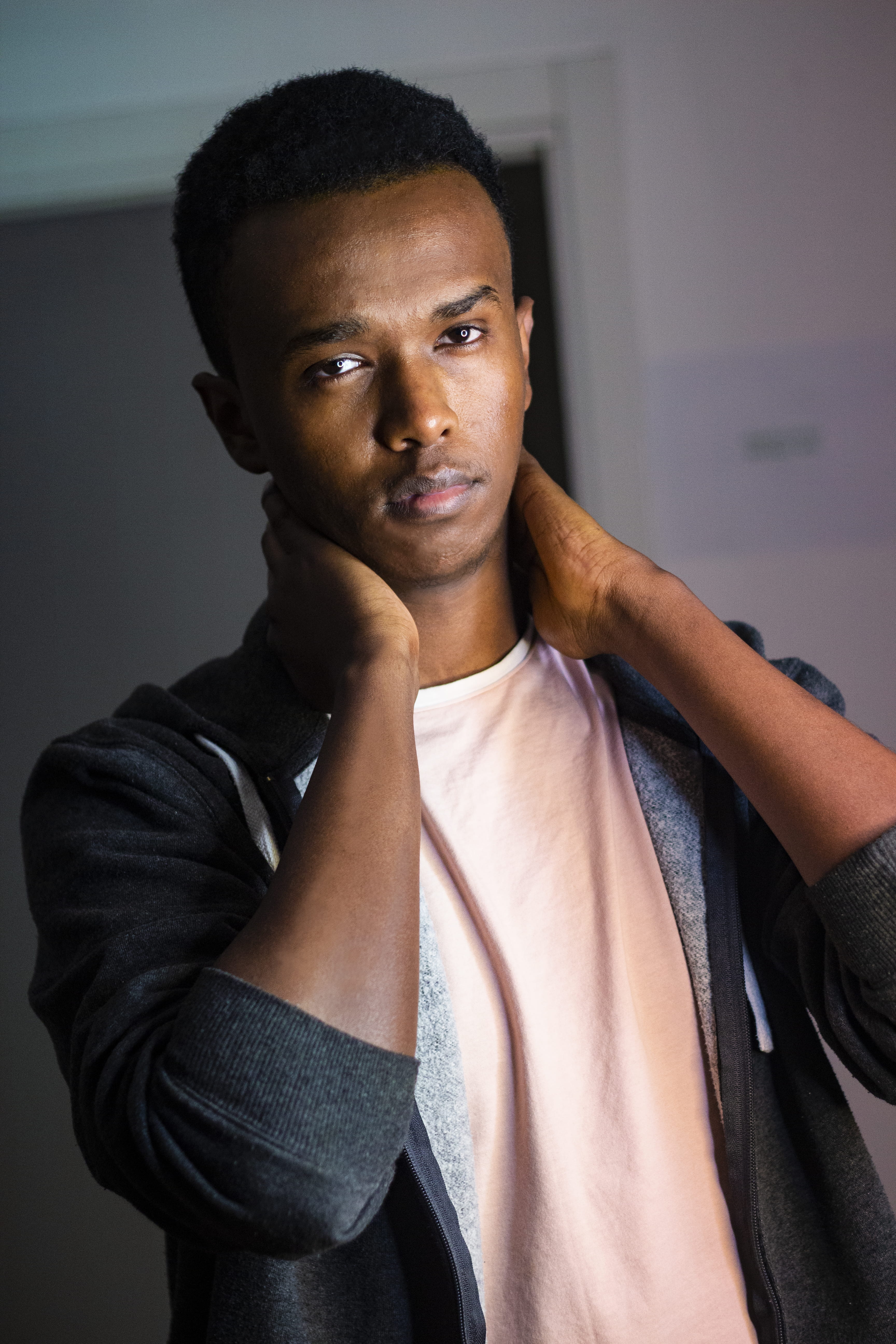 man holding neck with both hands, human, person, clothing, apparel