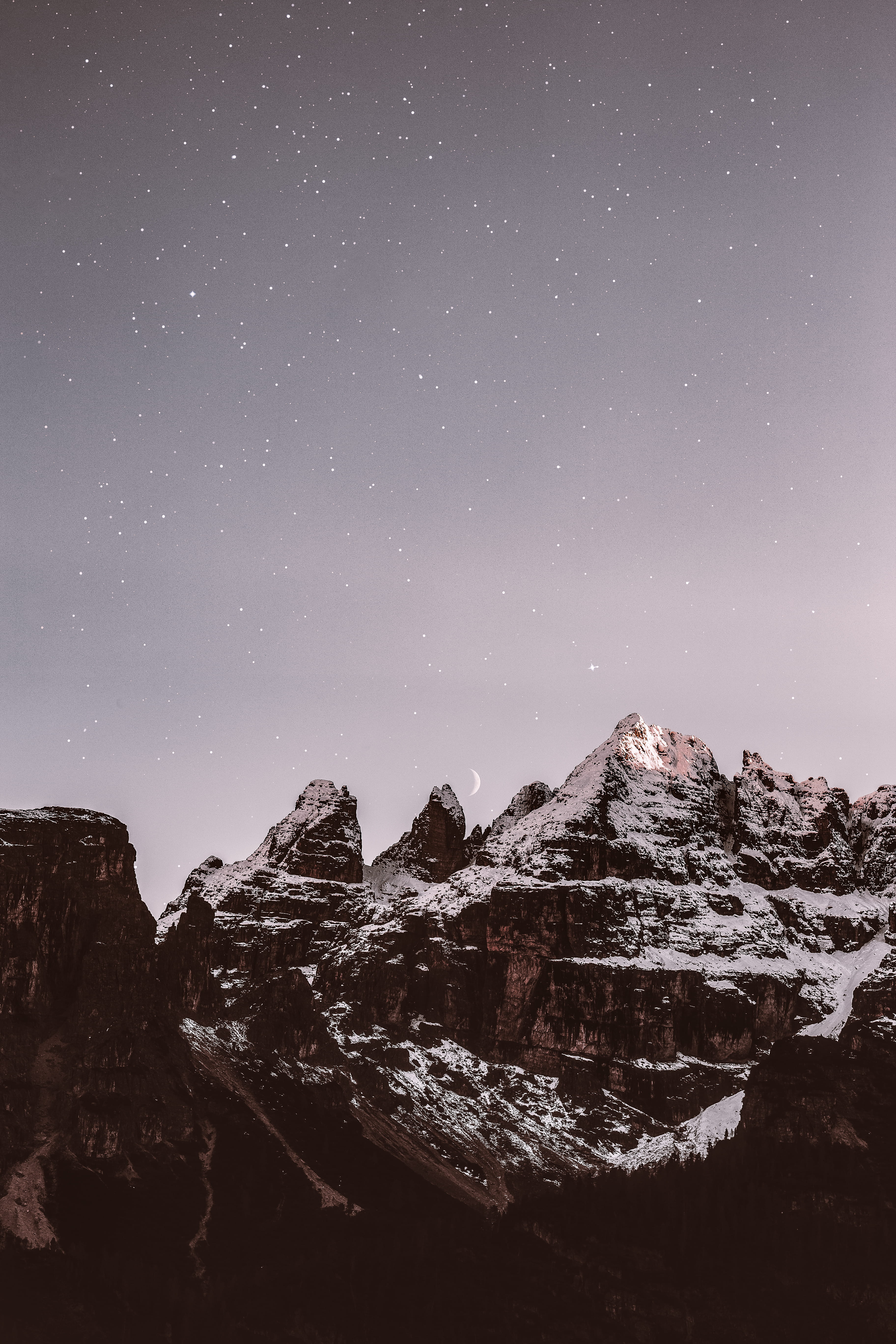 mountain range covered by snow during nighttime, star - space