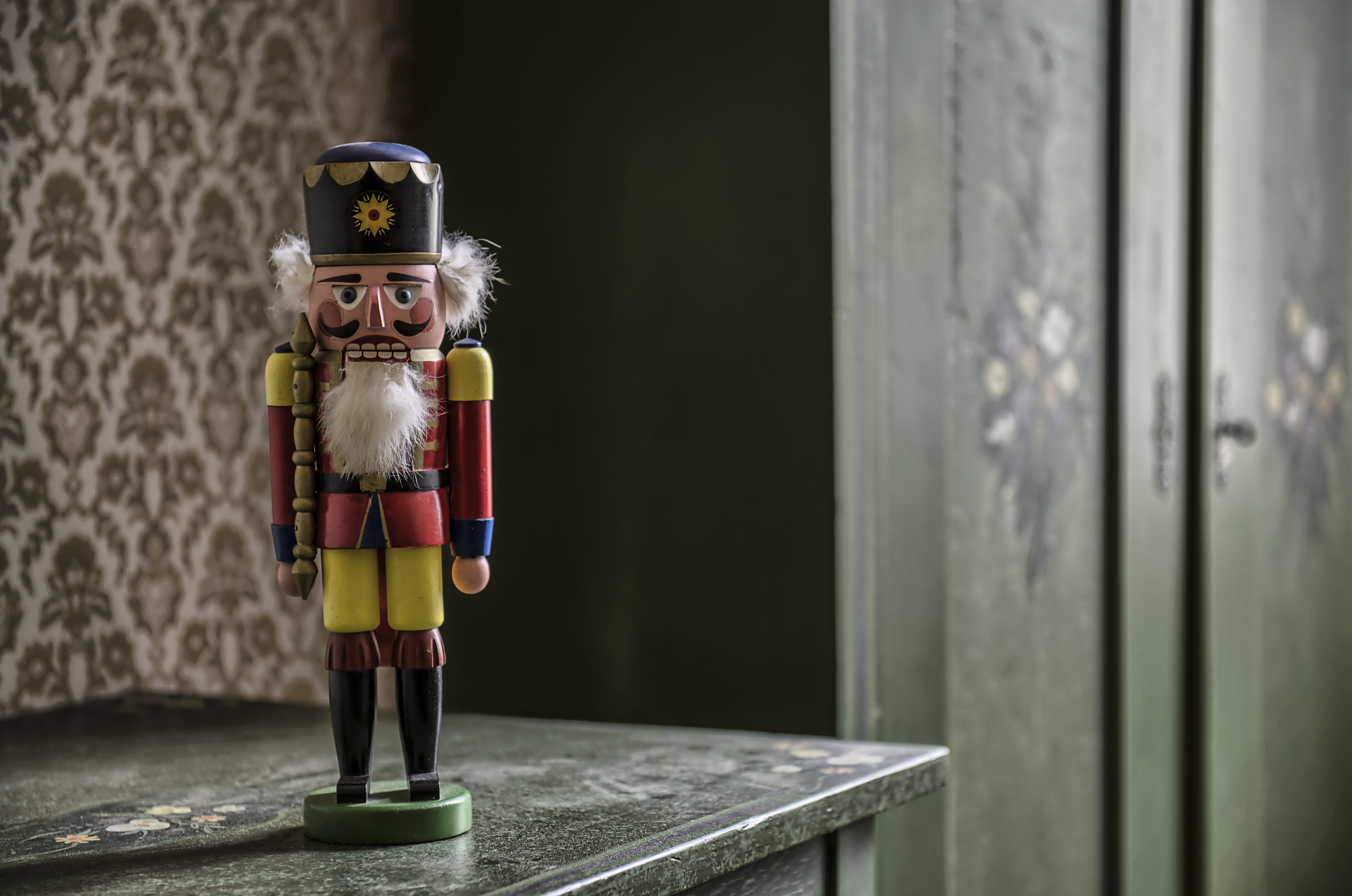 nutcracker on gray table, toy, representation, focus on foreground