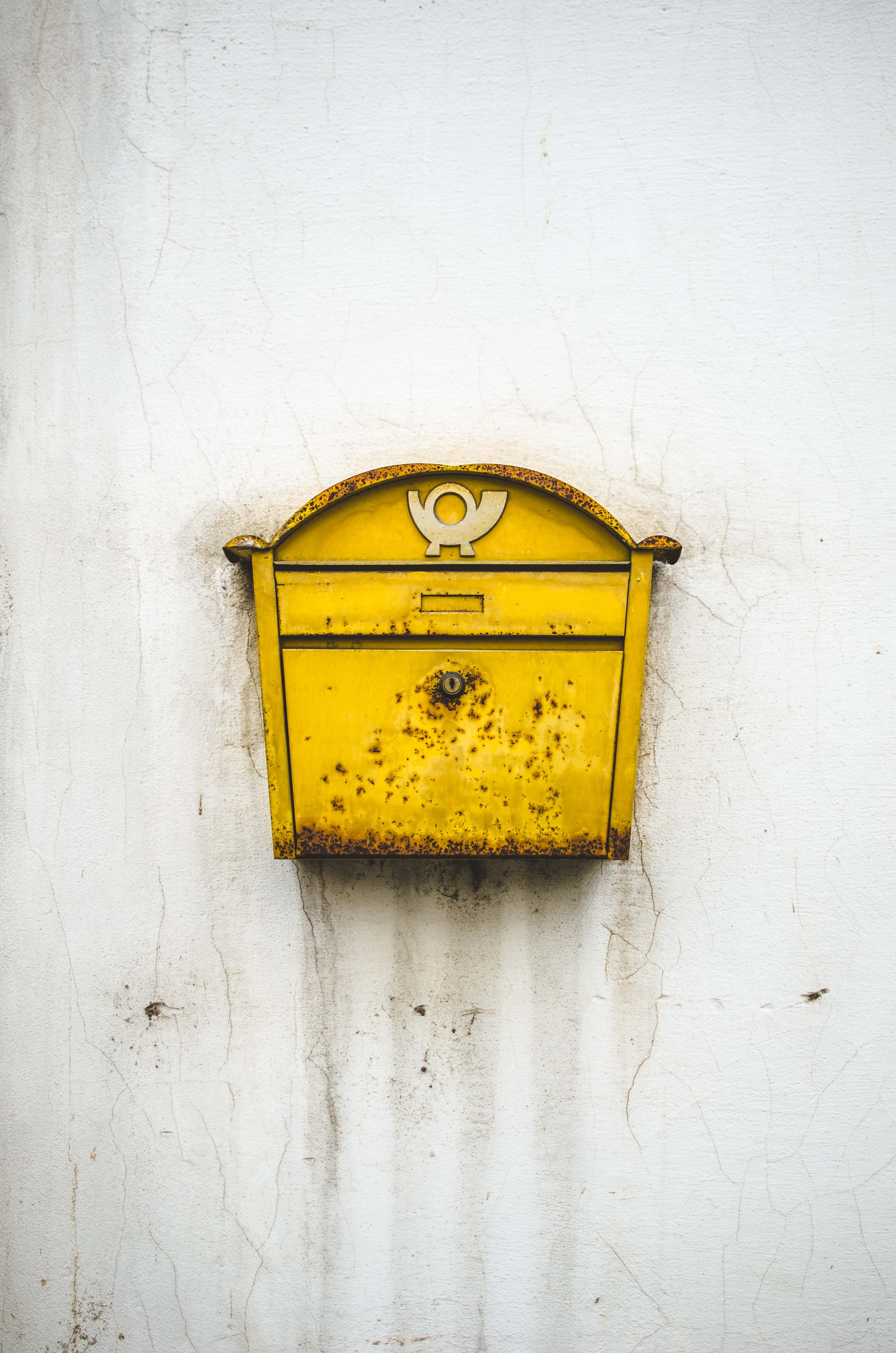 brass-colored mailbox, wall - building feature, yellow, no people