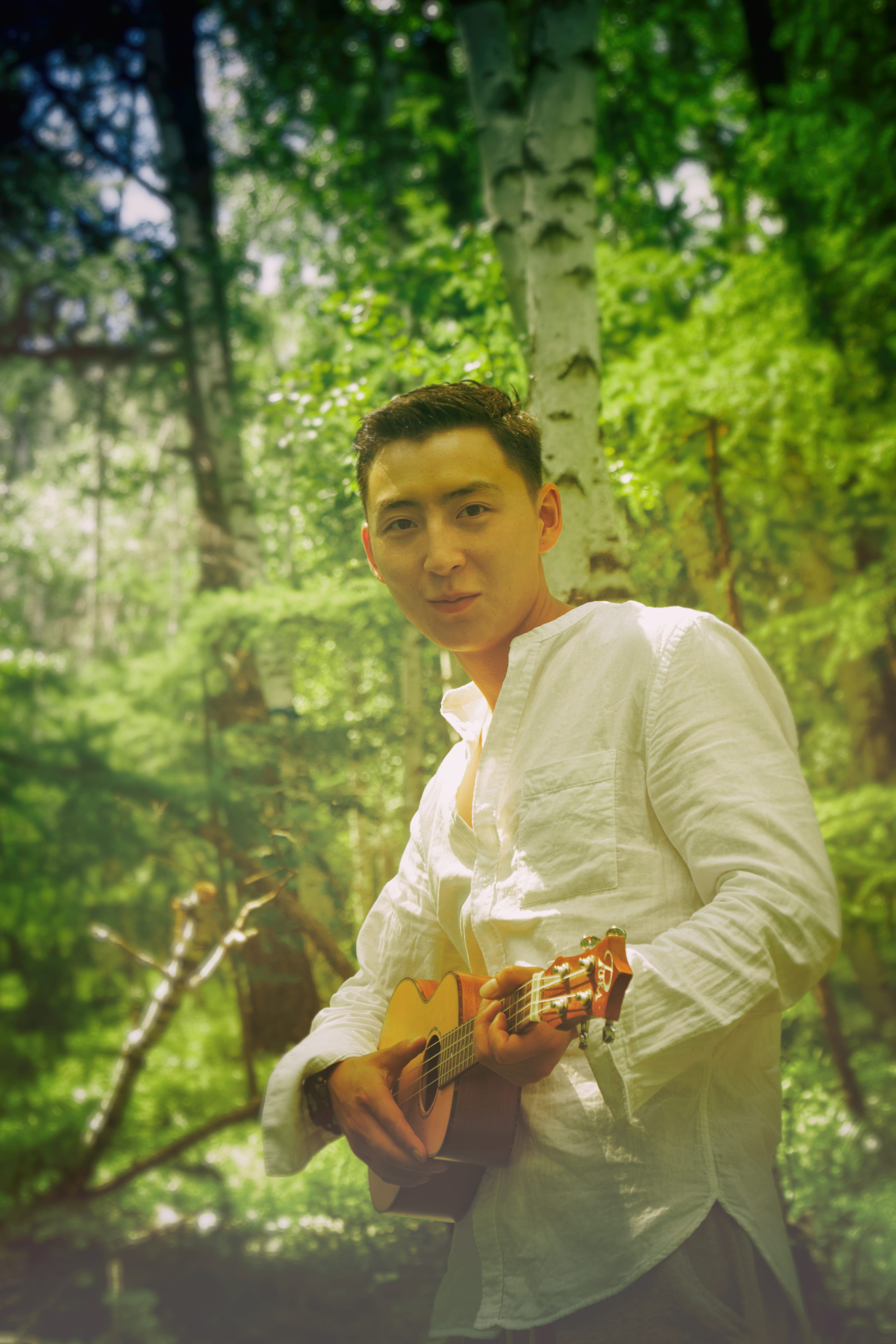 man wearing white dress shirt holding brown ukulele, human, person