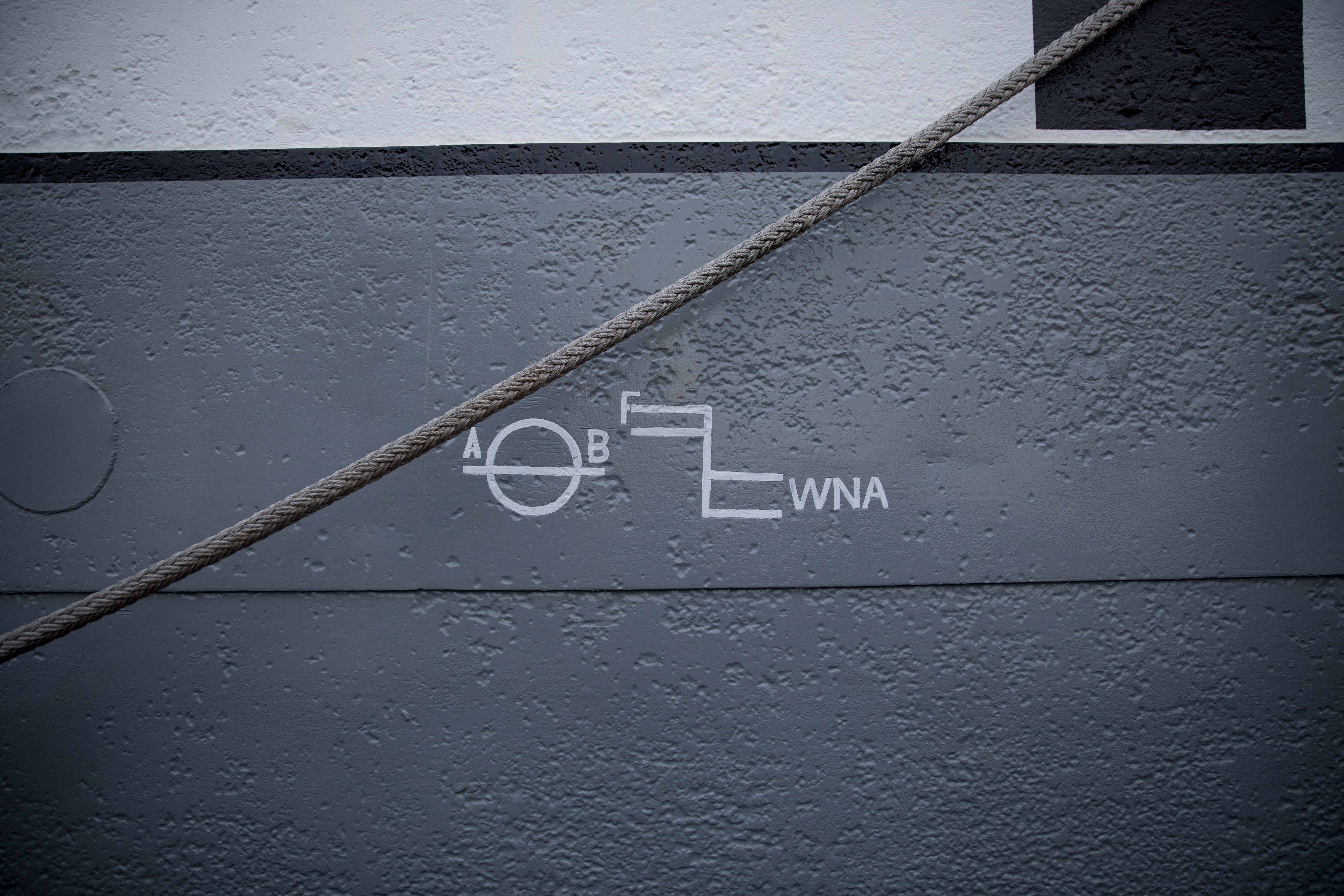 gray rope, western script, text, communication, no people, architecture
