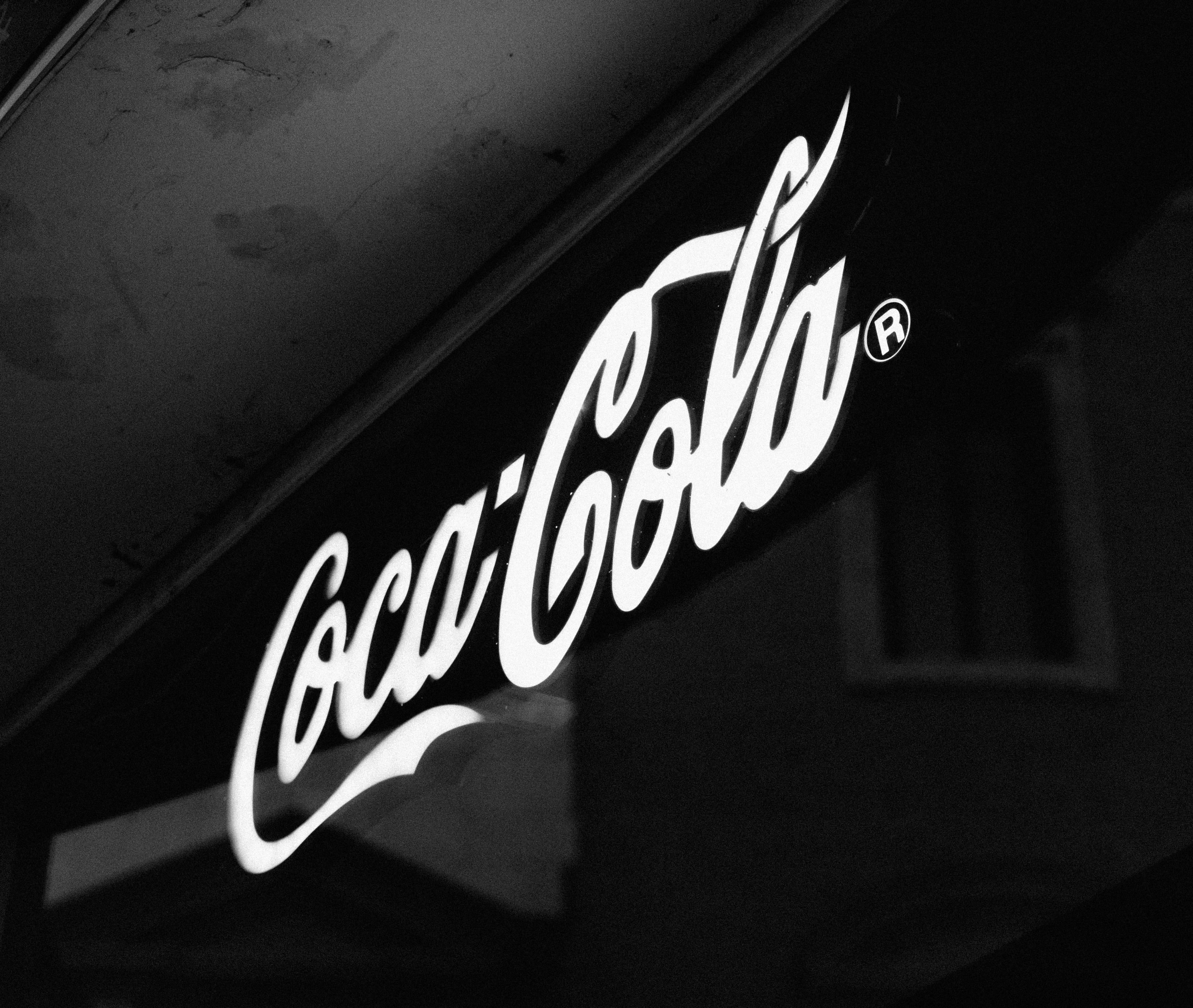 Coca-Cola sign, symbol, trademark, logo, alphabet, text, light