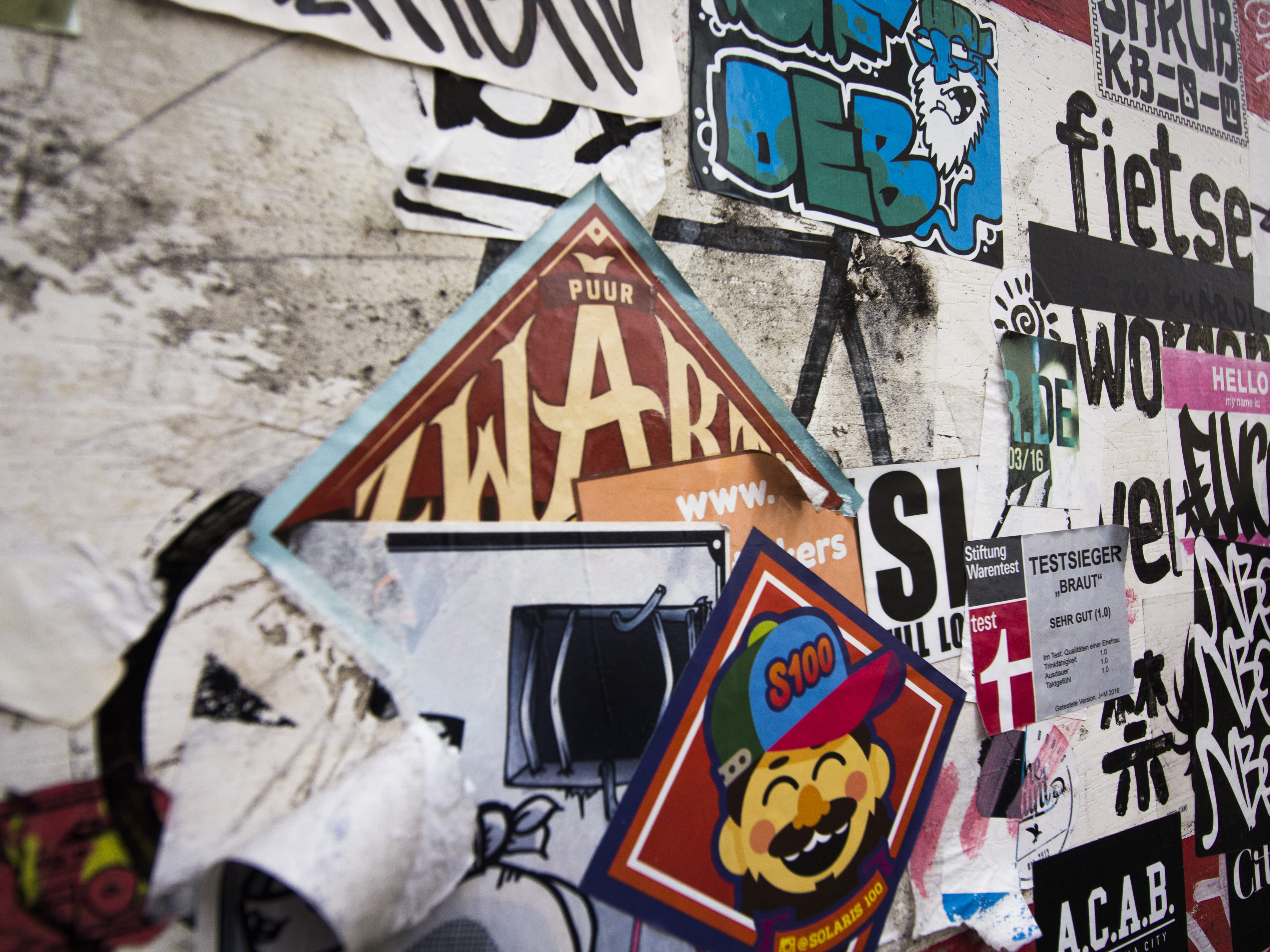 assorted stickers onwall, text, label, graffiti, art, symbol