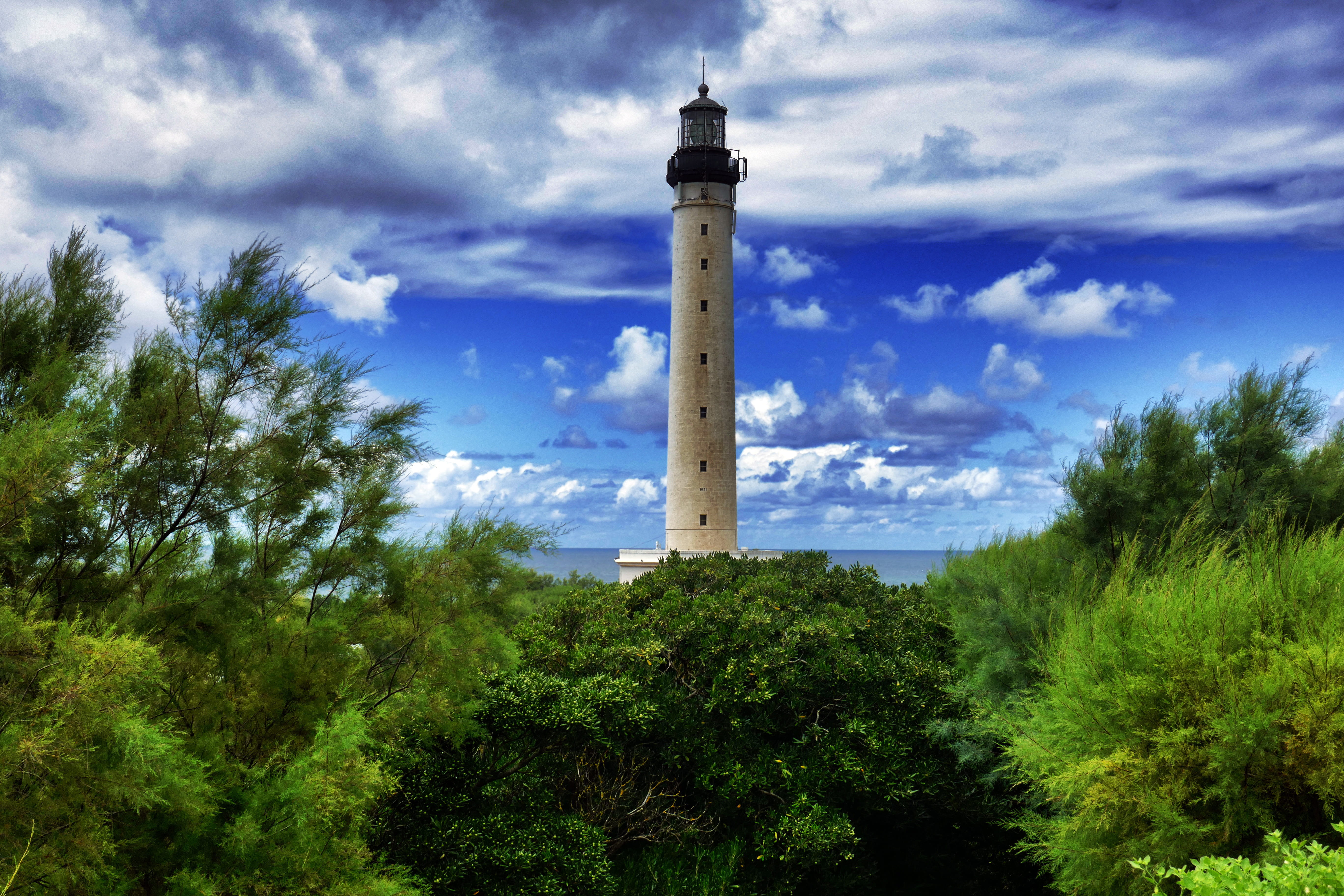white lighthouse surrounded by trees, architecture, building