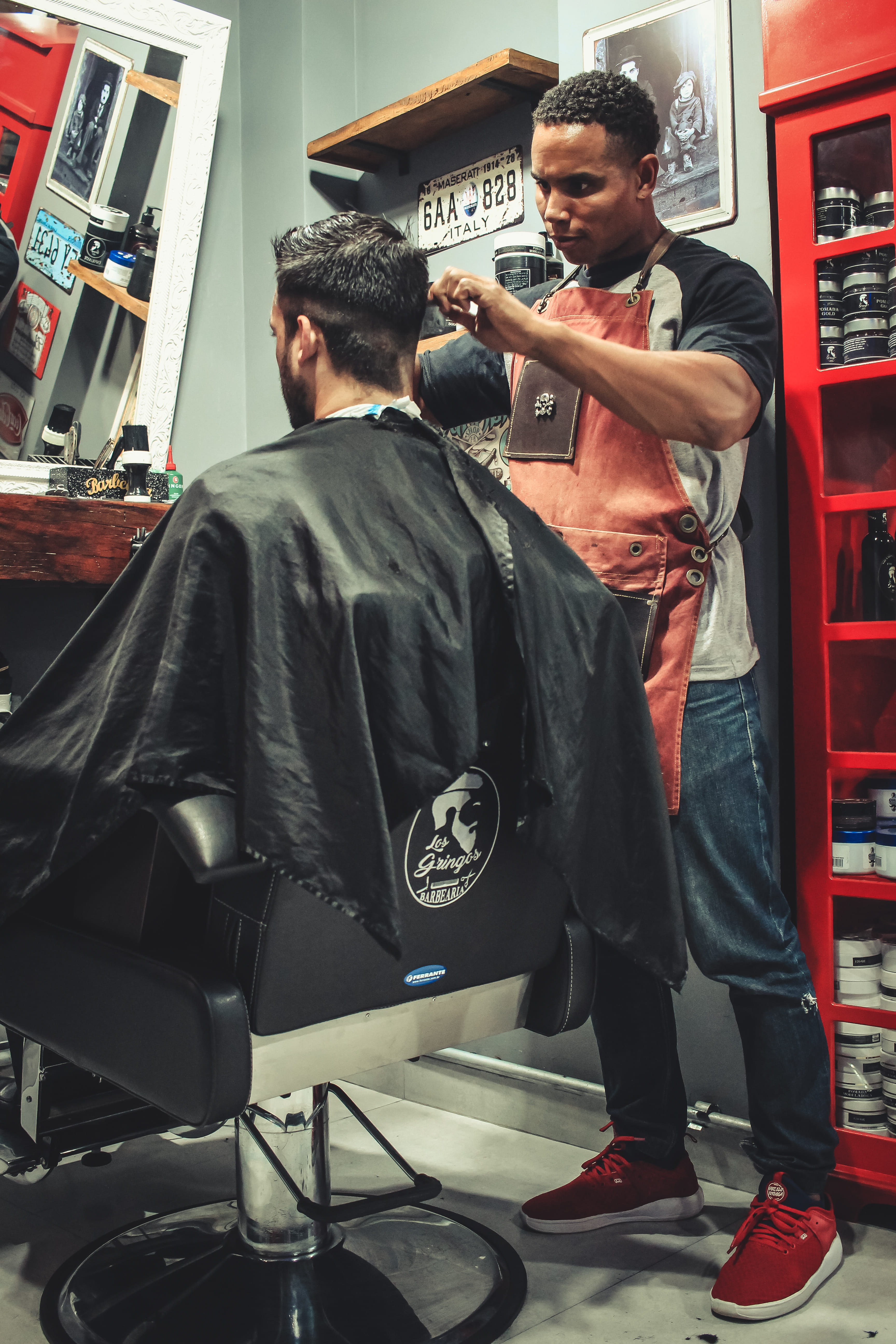Man Cutting Hair Man While Sitting on Barber's Chair, barbershop