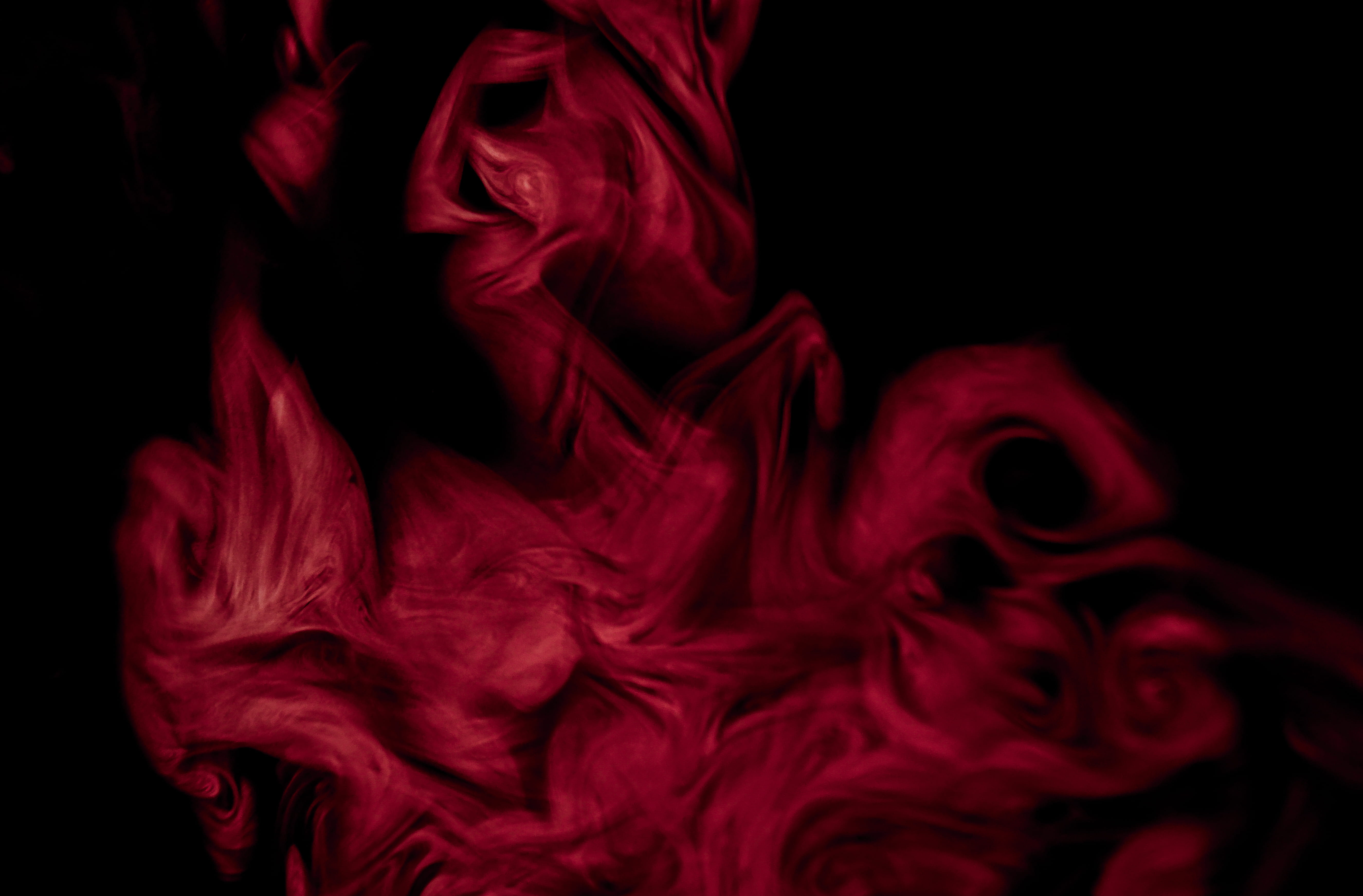 red flame, black background, studio shot, indoors, close-up, motion