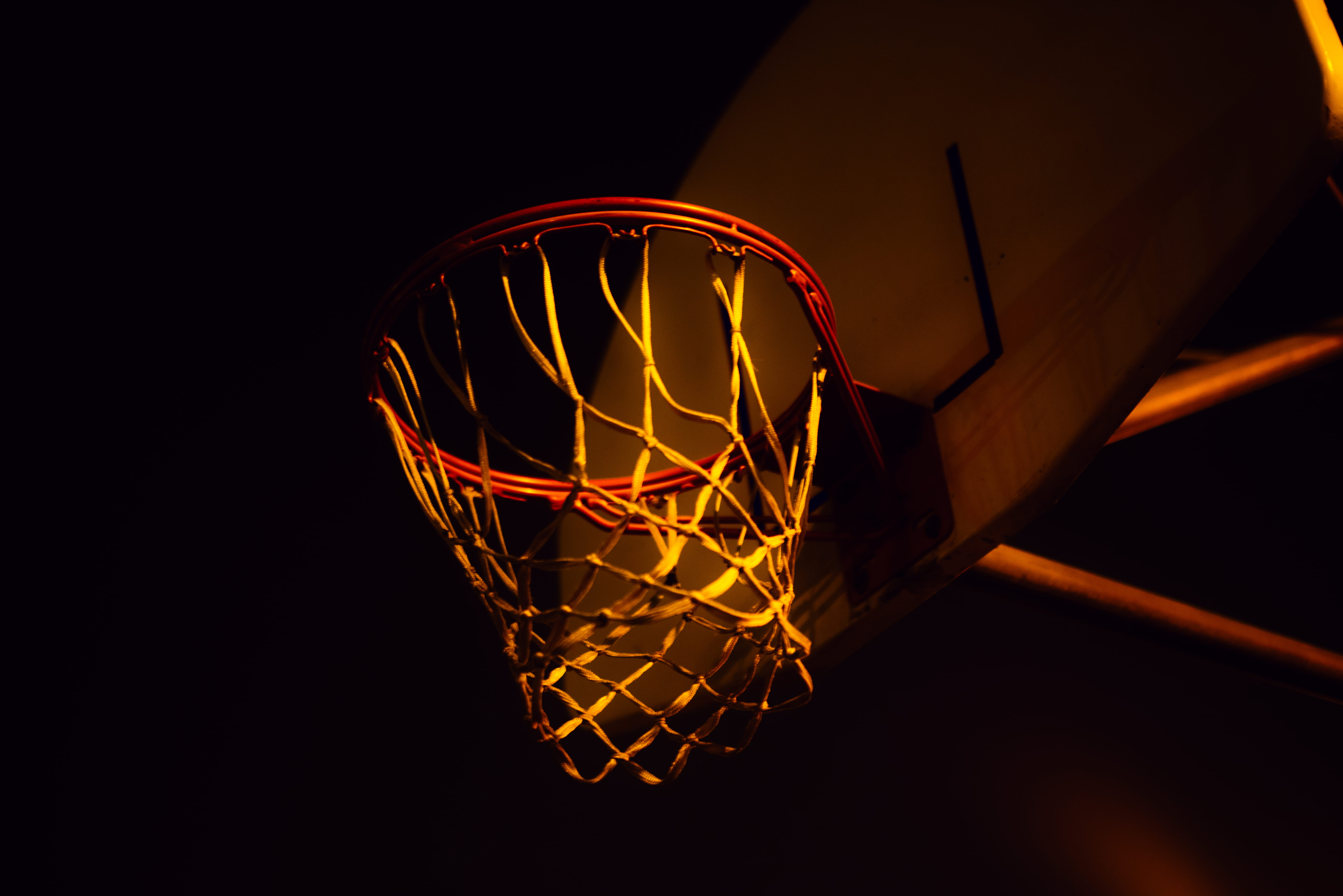 red and white basketball hoop with net, banister, handrail, lamp
