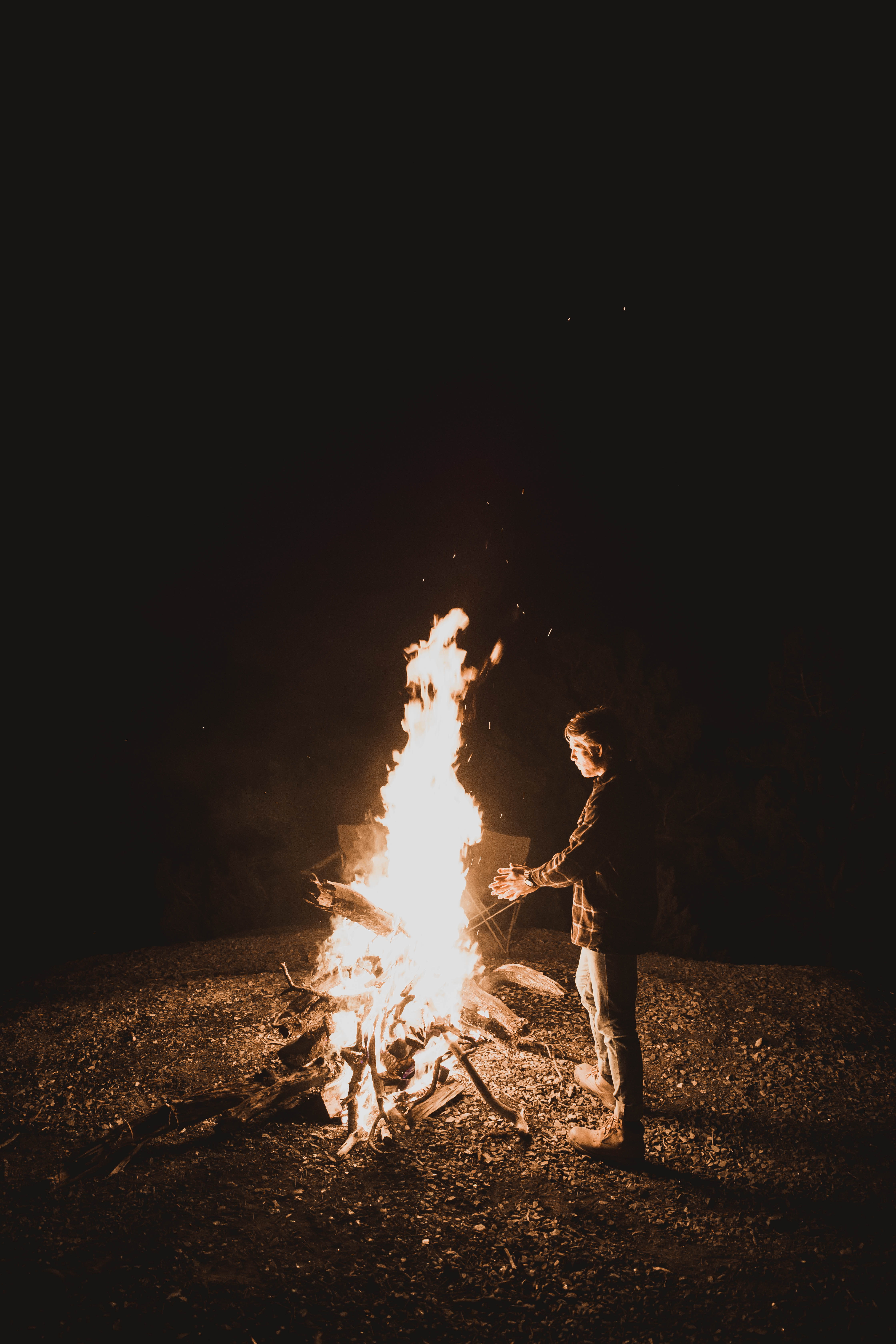 man standing near fire pit, human, person, bonfire, flame, night