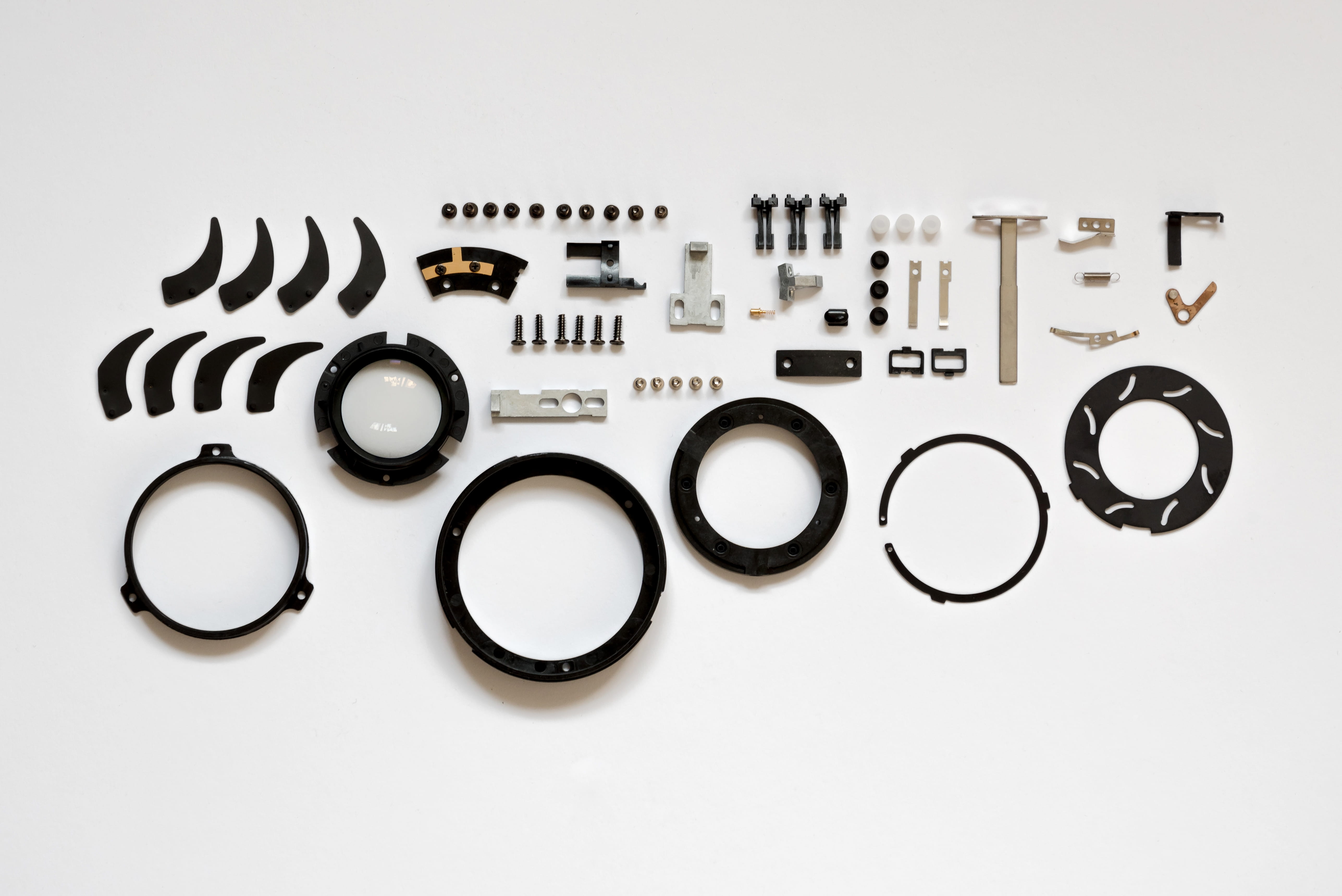 Assorted Item Lot on White Surface, broken, close-up, focus, gear