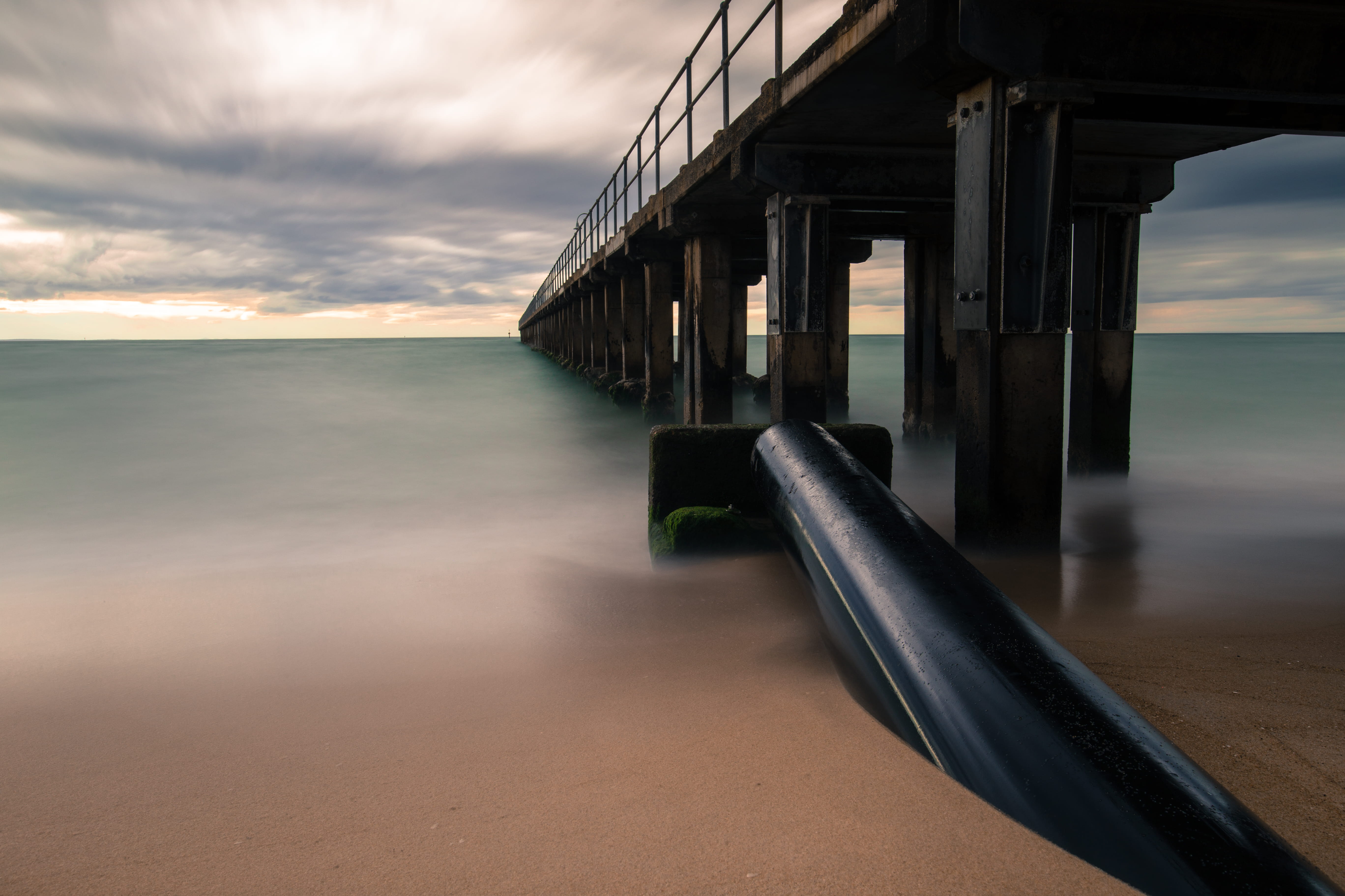 skyline photography of black bridge, pier, ocean, sea, water