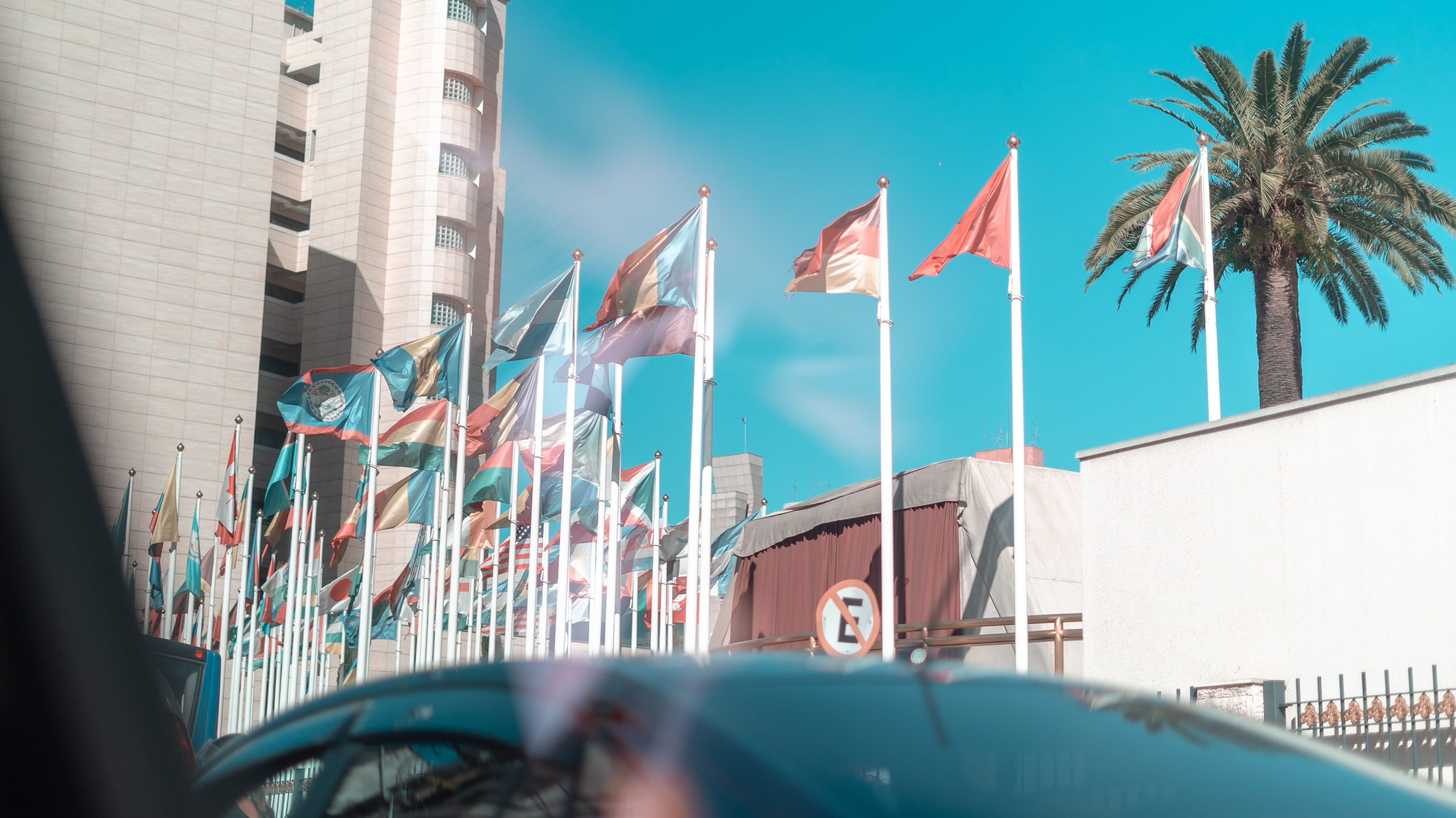 assorted flags during daytime, architecture, built structure