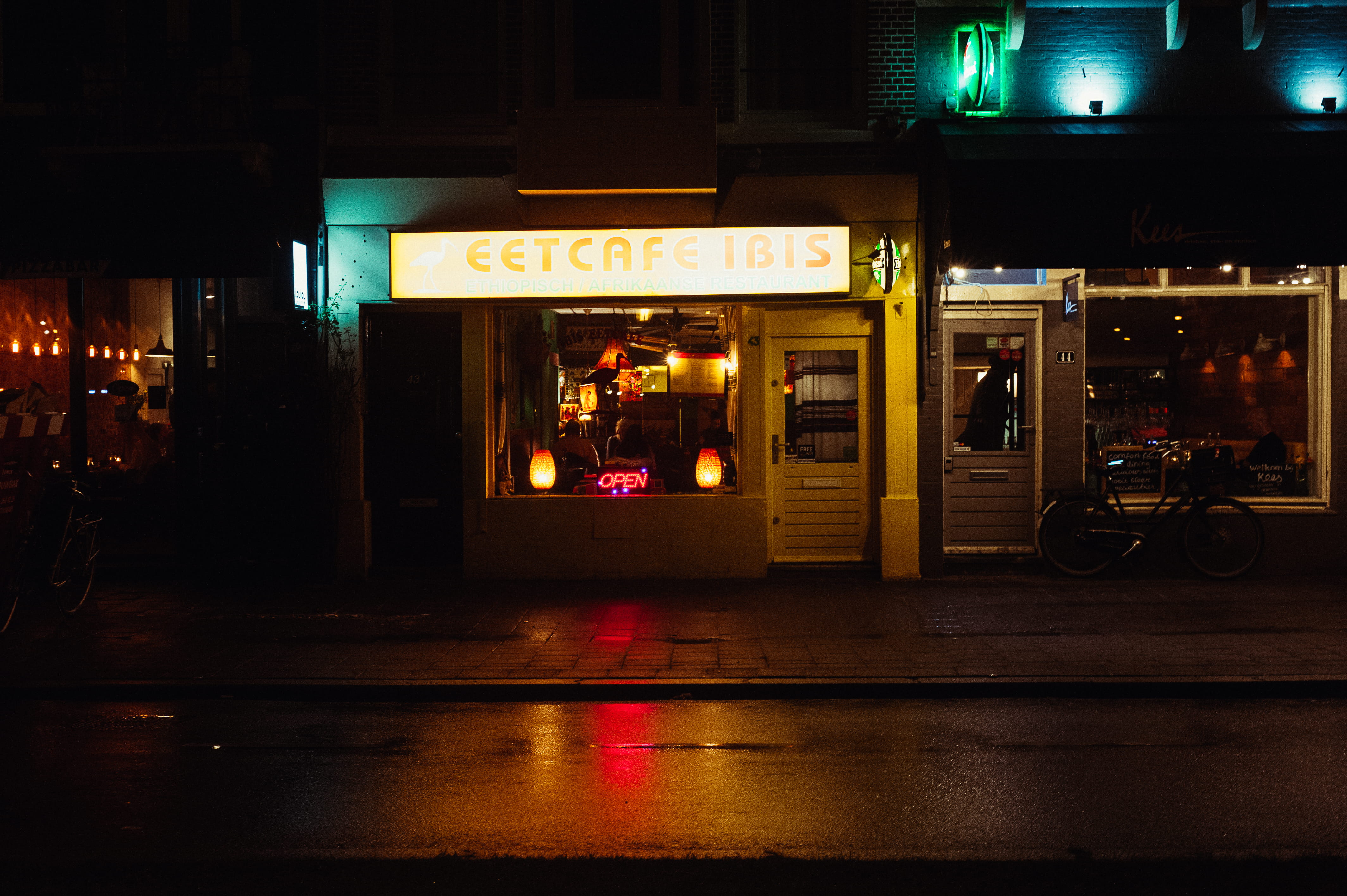 Eetcafe storefront, illuminated, night, communication, text, architecture