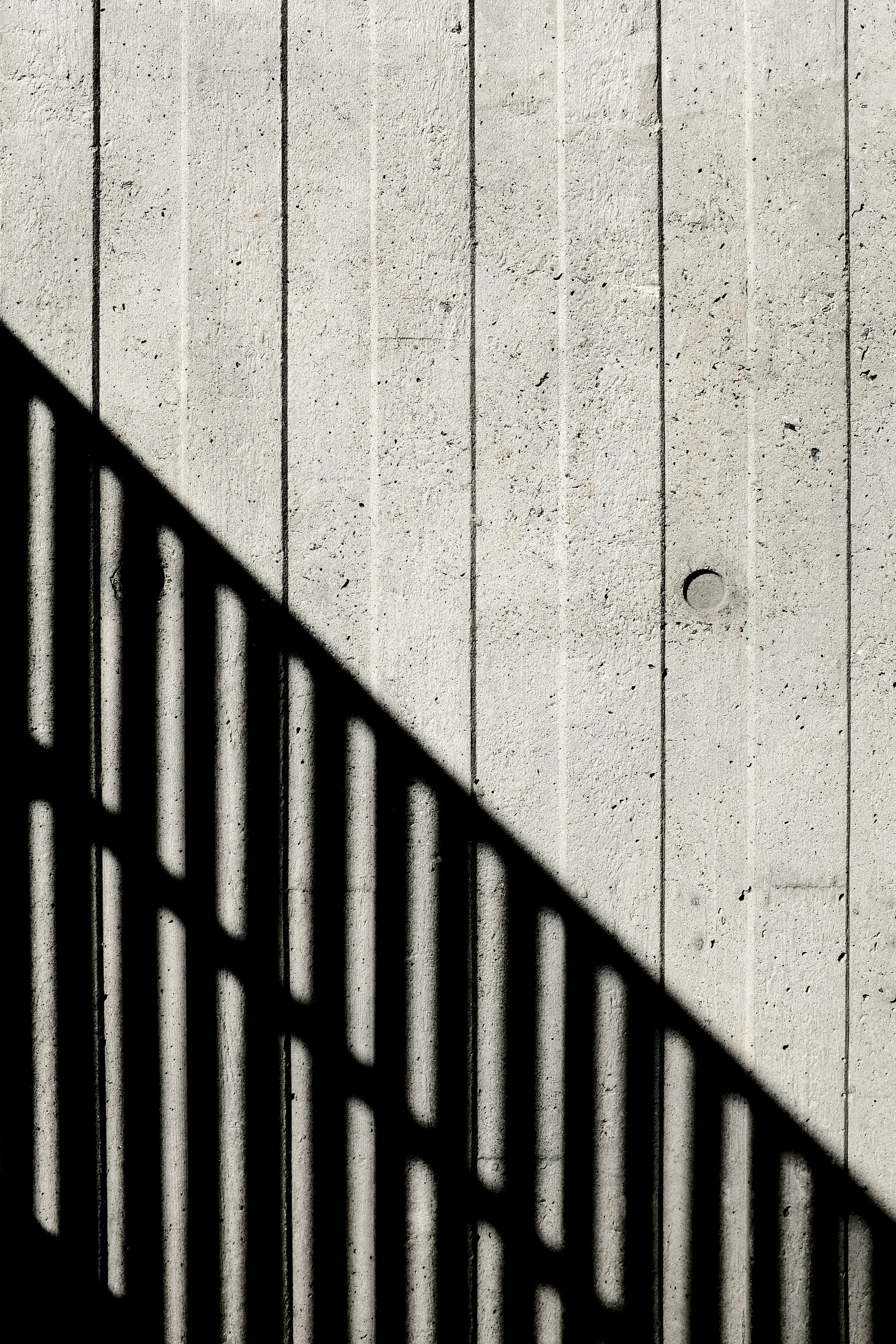 gray wall paint, concrete, shadow, light, pattern, texture, closeup