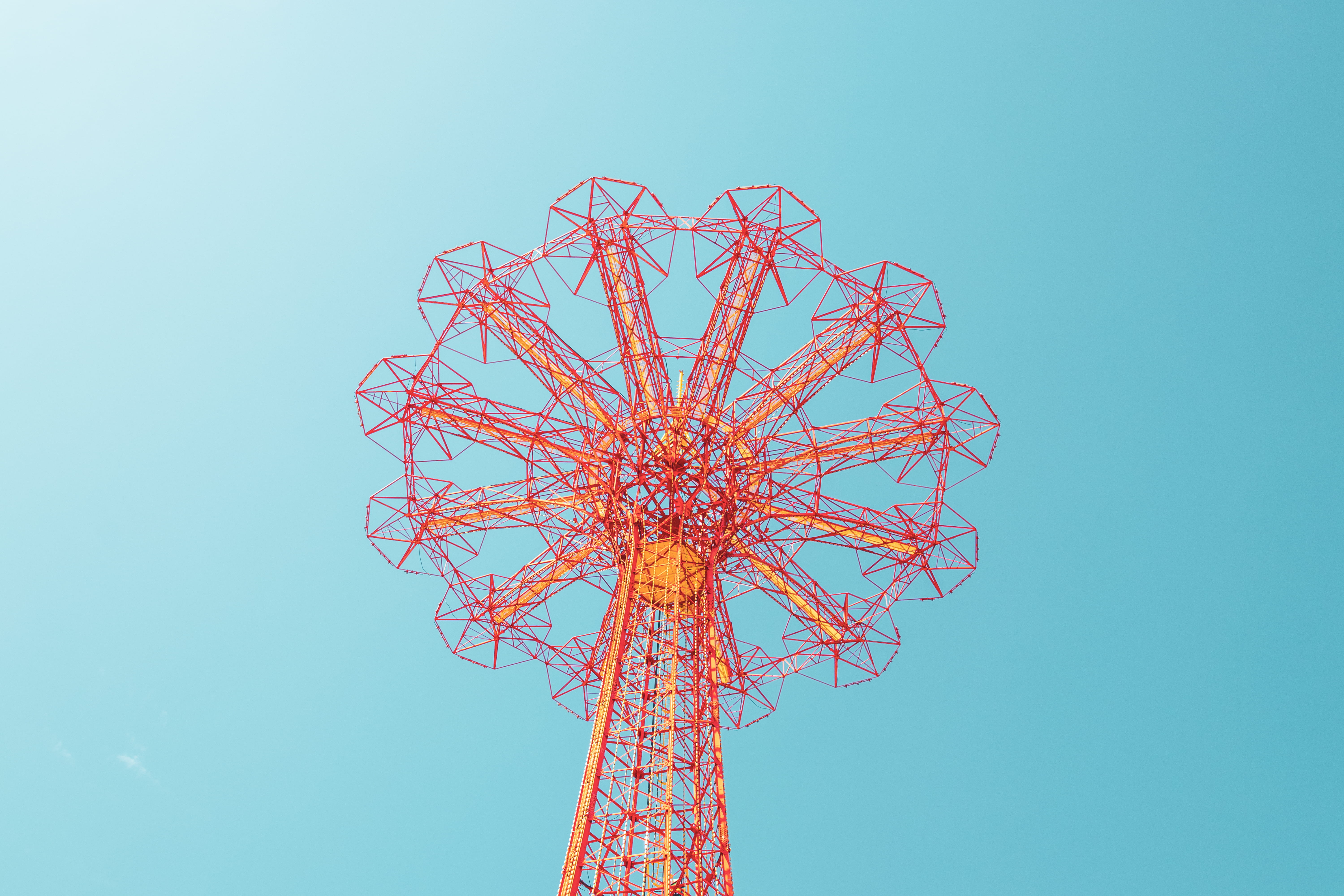 orange high-rise structure, sky, low angle view, amusement park