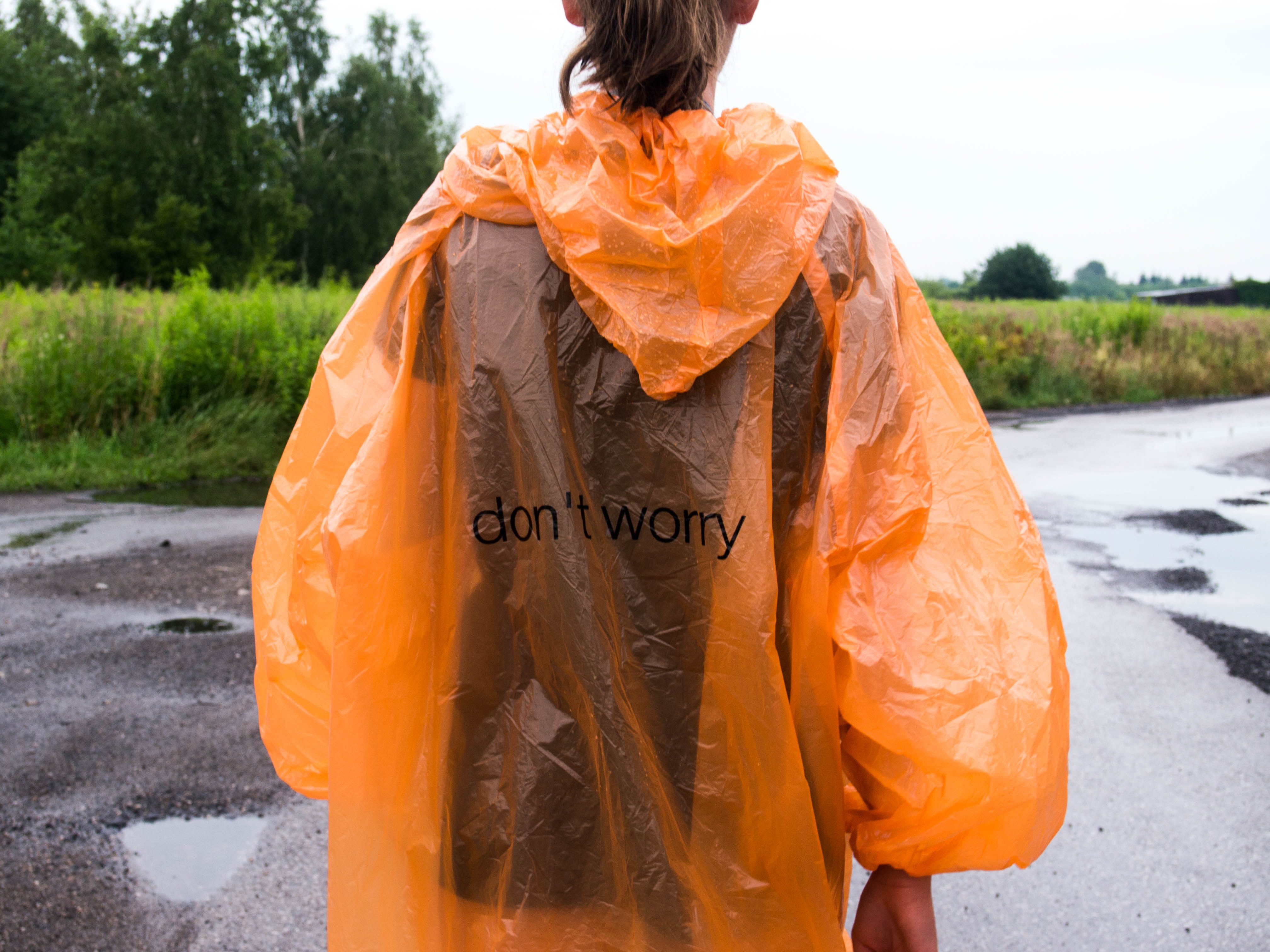 rain, poncho, one person, text, rear view, western script, standing