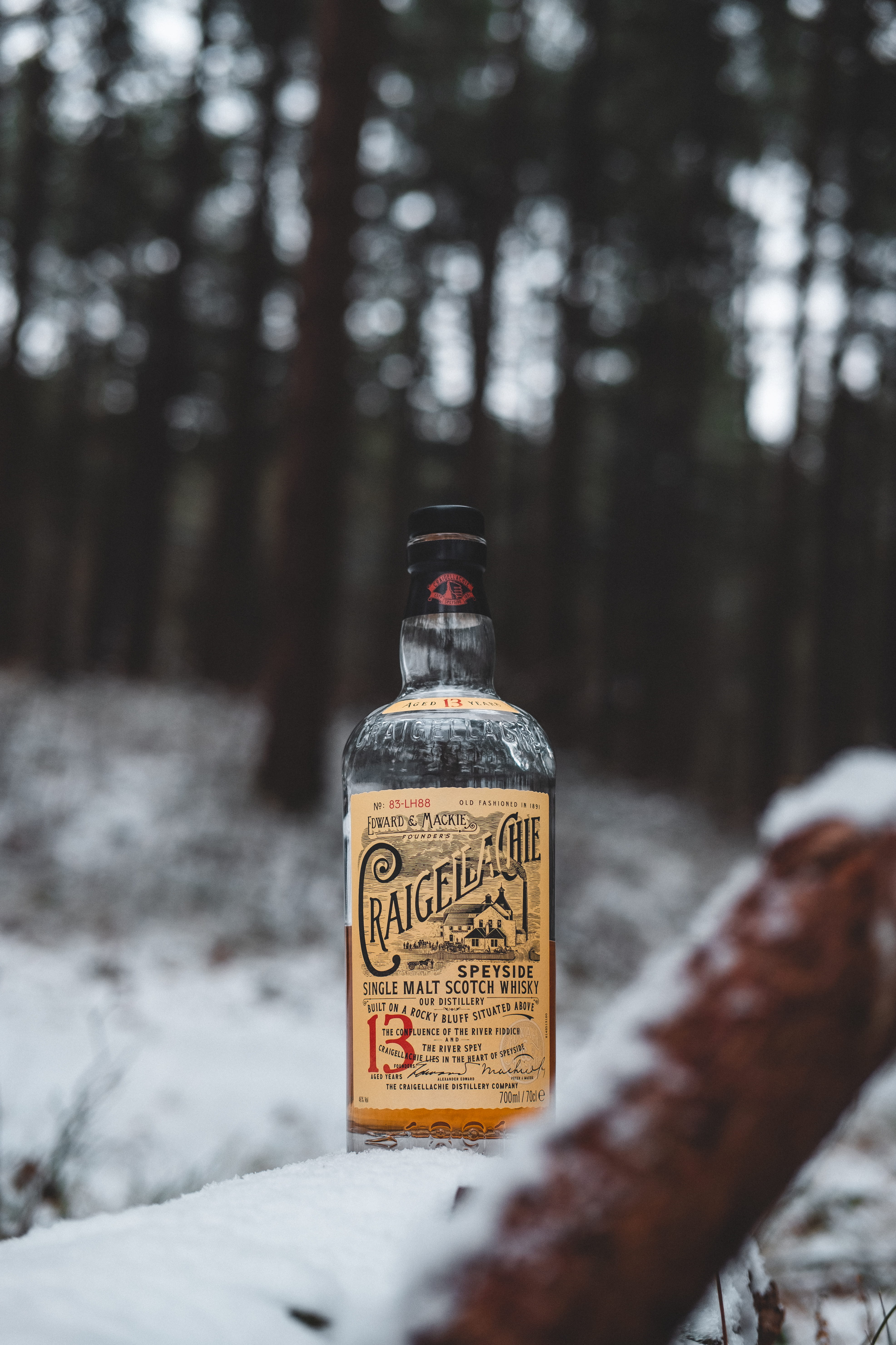 Craigelagie scotch whisky bottle on snow at the woods, text, cold temperature
