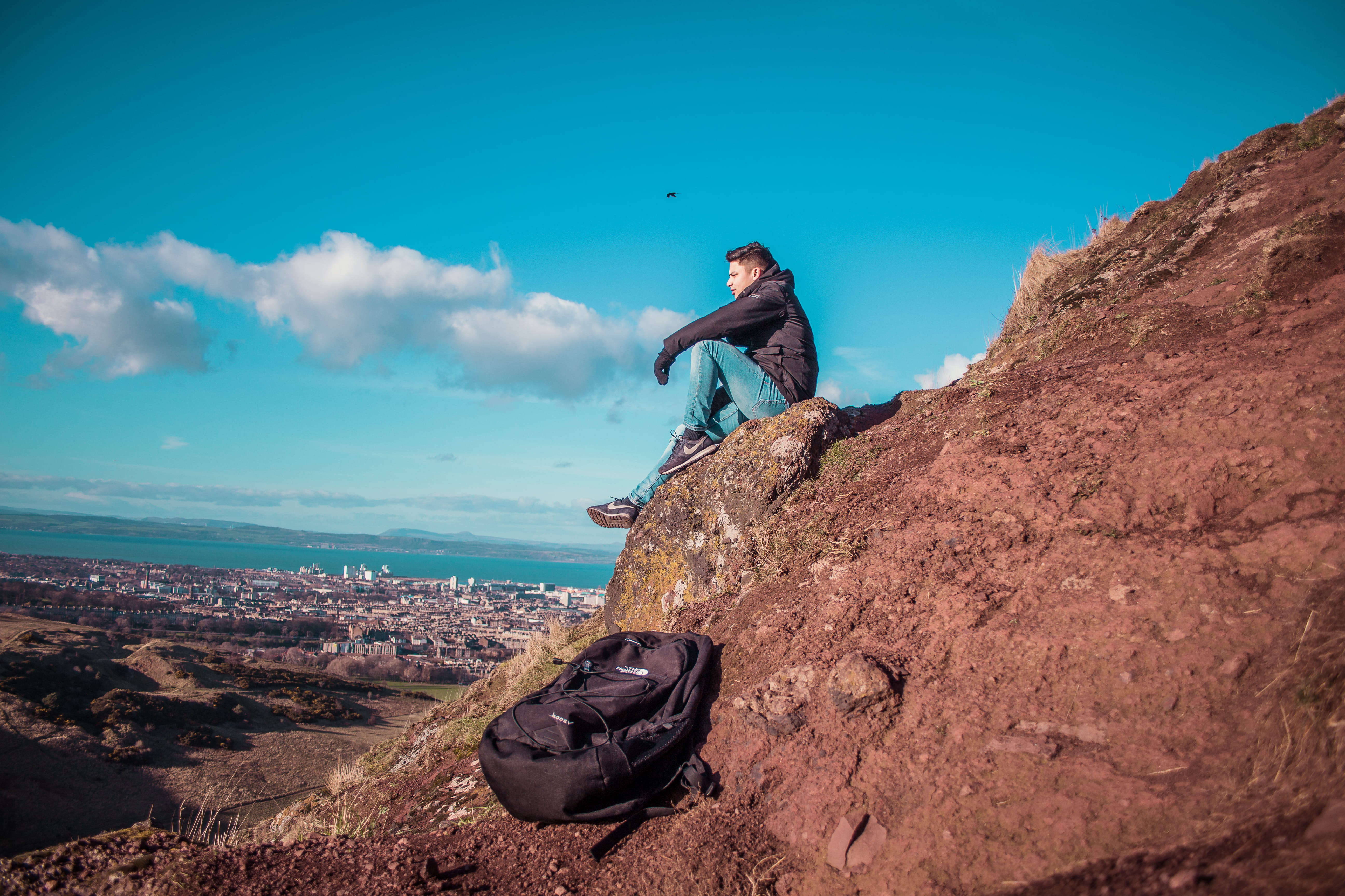 man sitting on mountain cliff, rock, rock - object, solid, one person