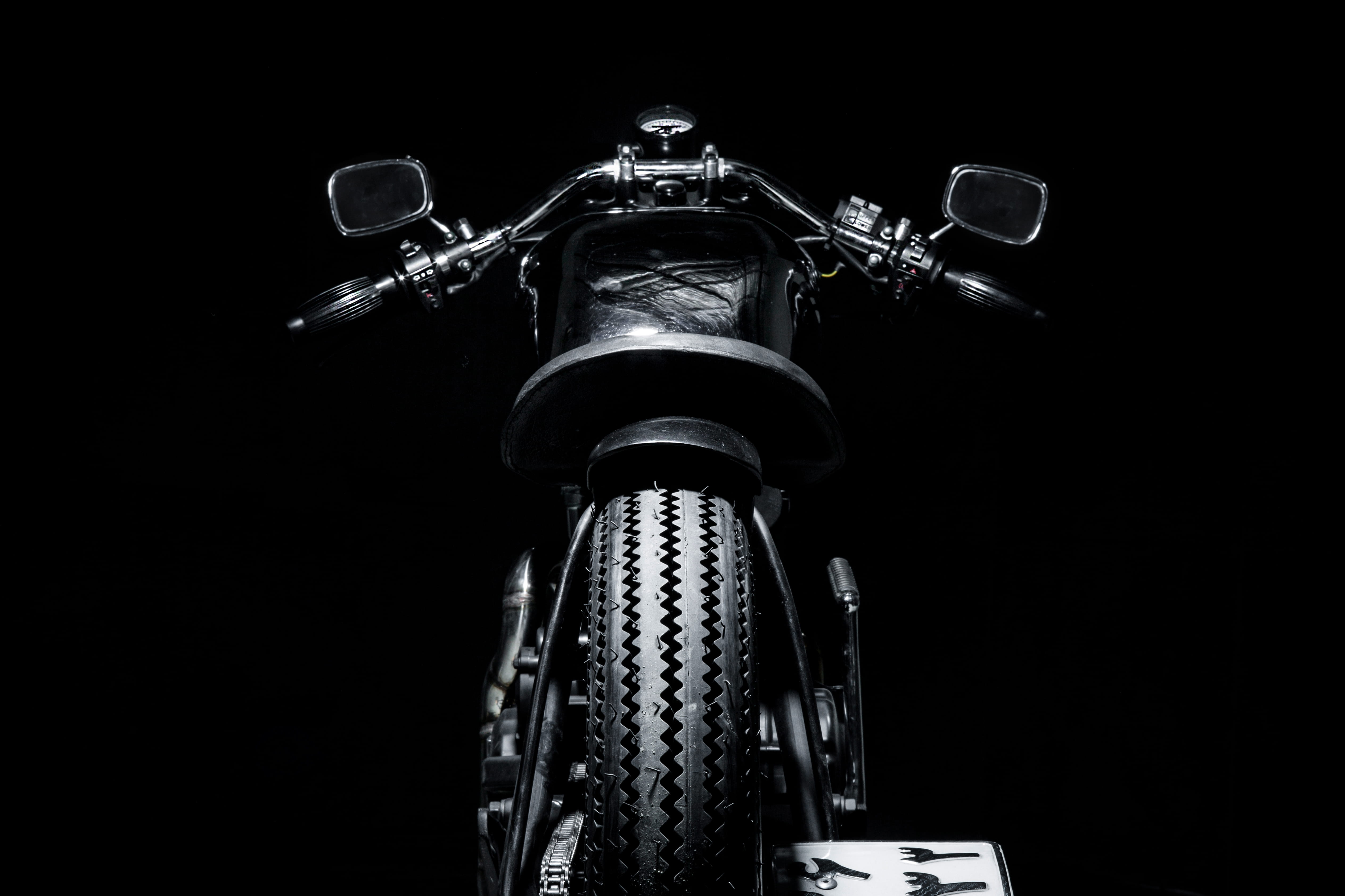 black motorcycle, low angle view, black background, no people