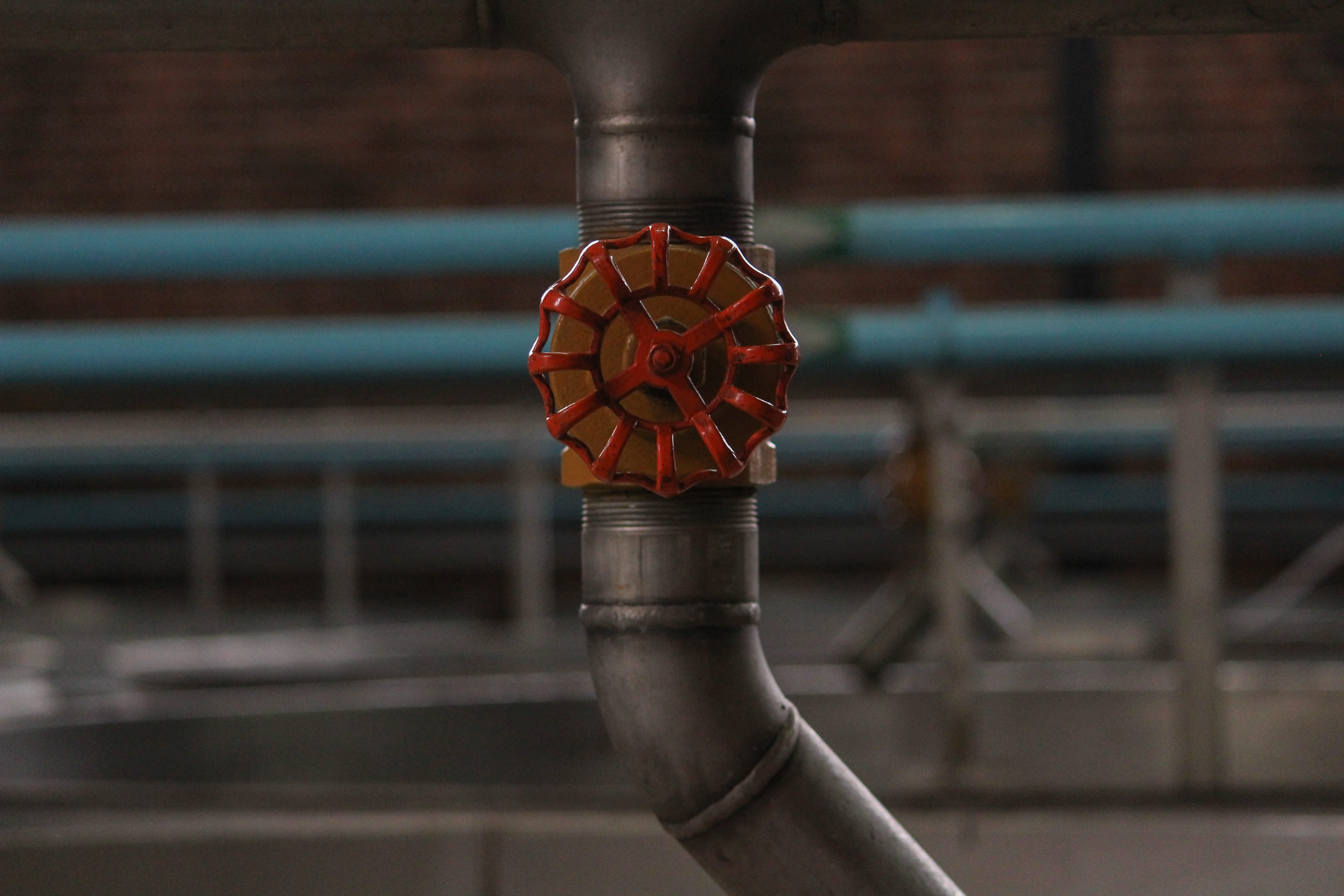 gray pipe, red, focus on foreground, close-up, human hand, day