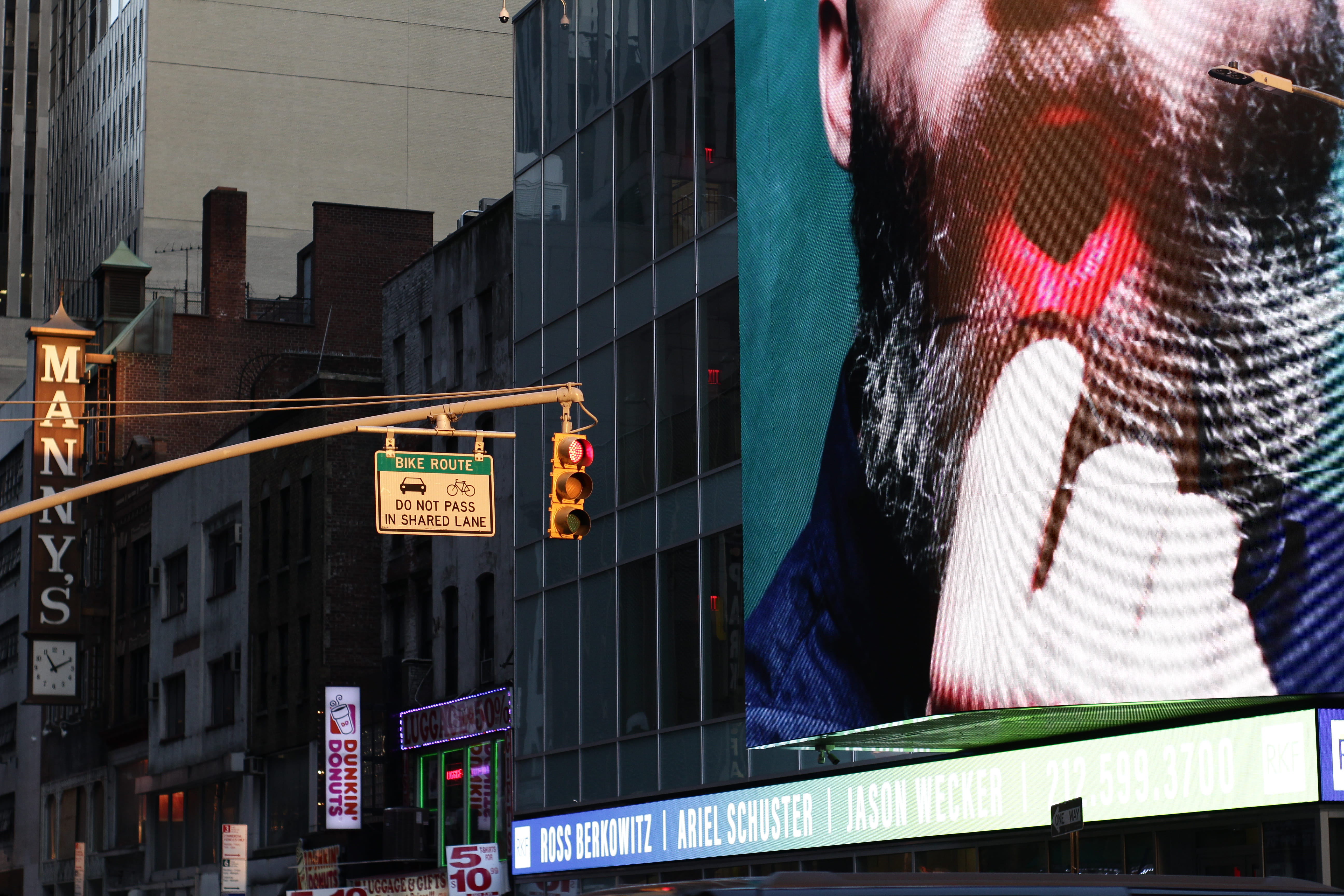 advertisement, traffic light, billboard, human, person, urban