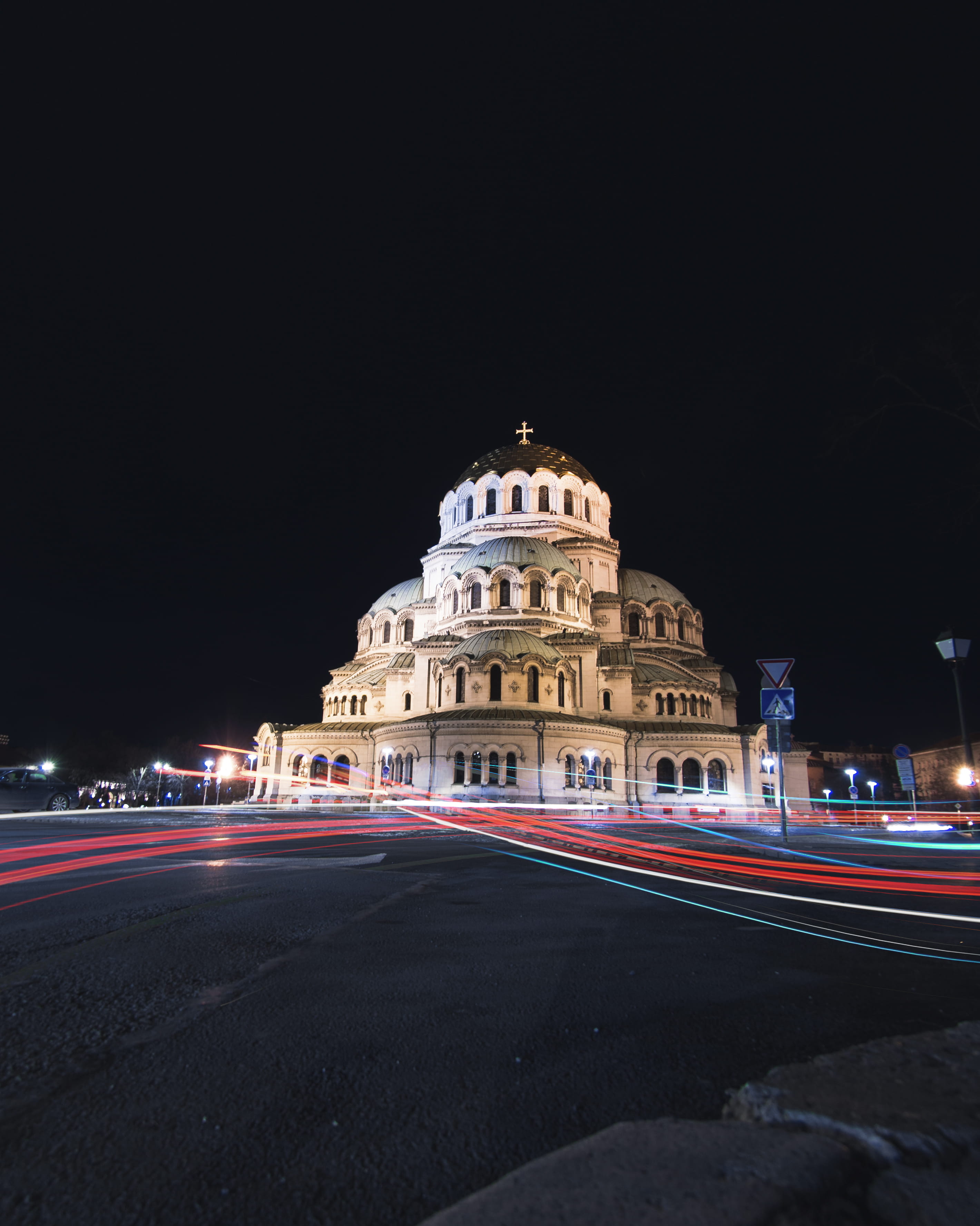 lighted cathedral at night by the road, built structure, architecture