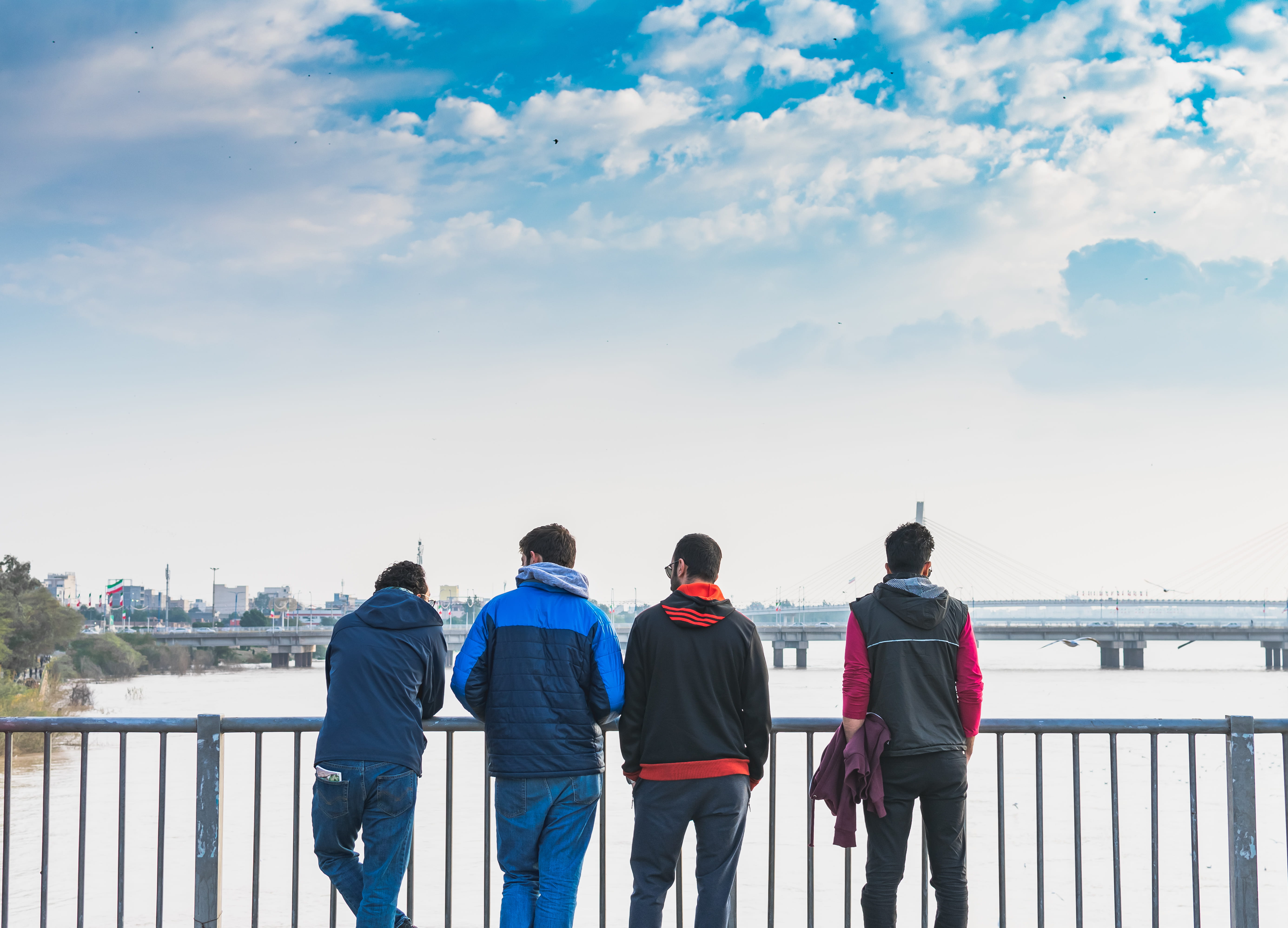 four man standing front on fence, human, person, railing, apparel
