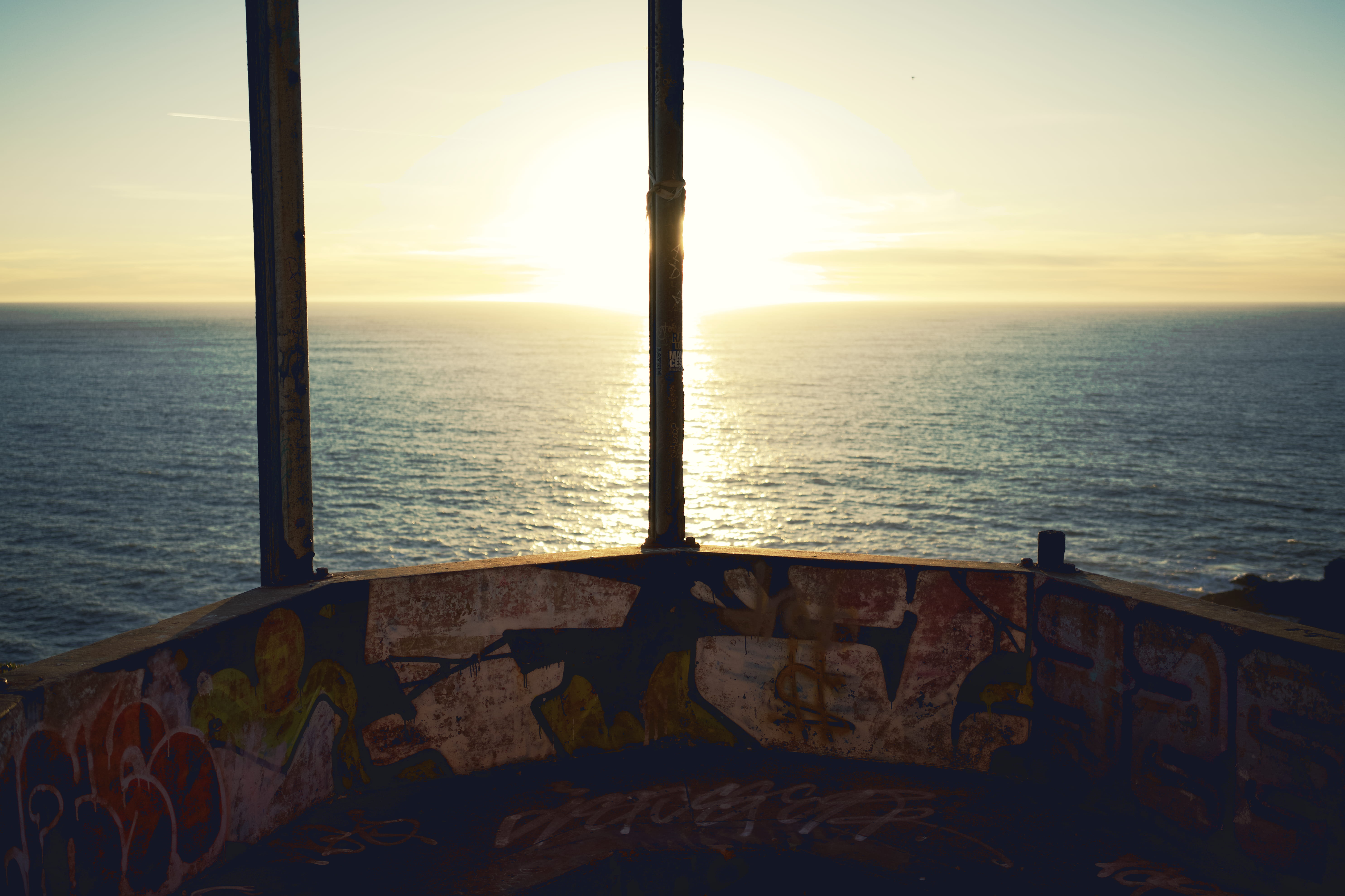 Ocean, graffiti, bunker, explode, explosion, sun, clouds, sunset