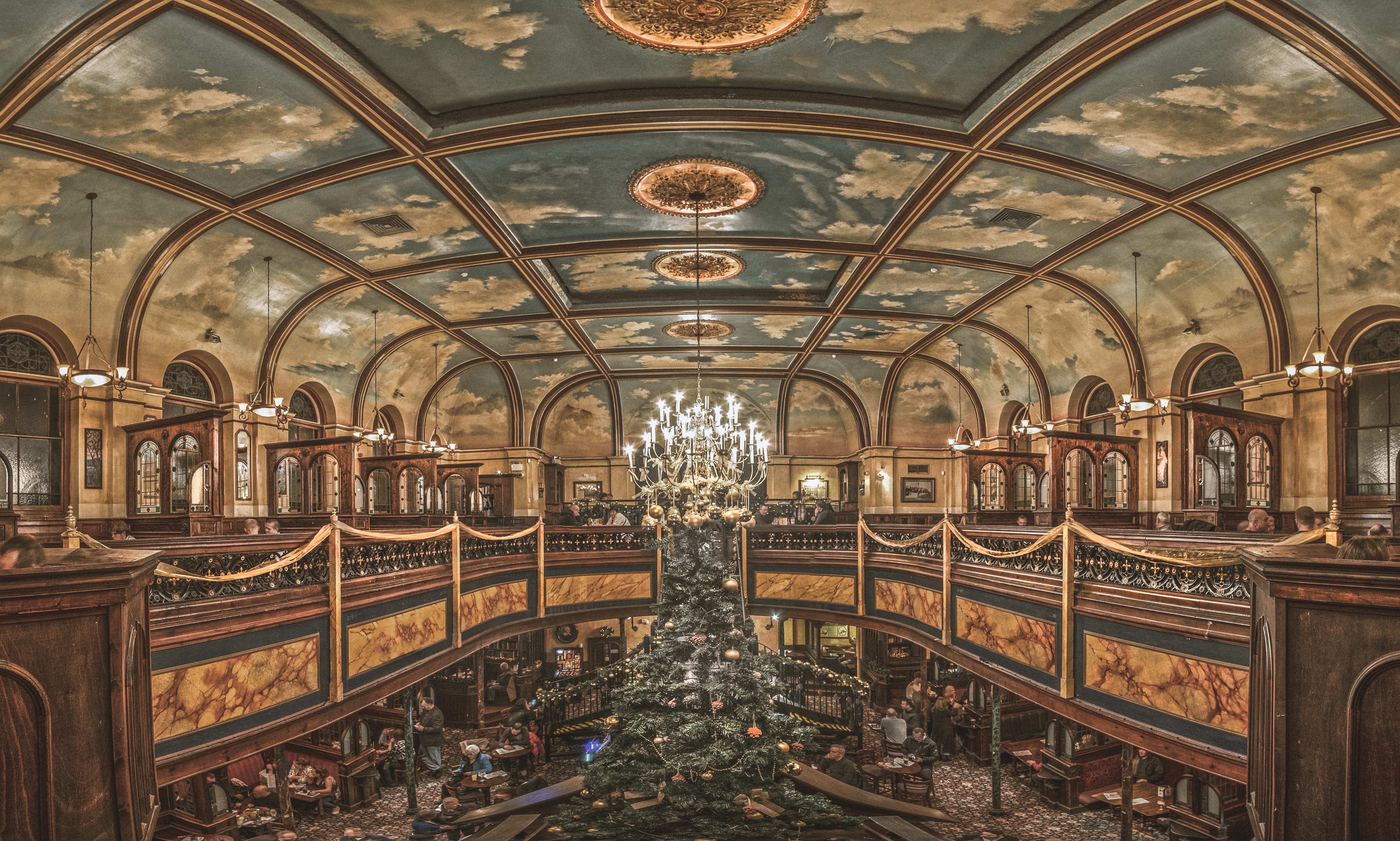 indoor view of brown and blue building with chandeliers turned on