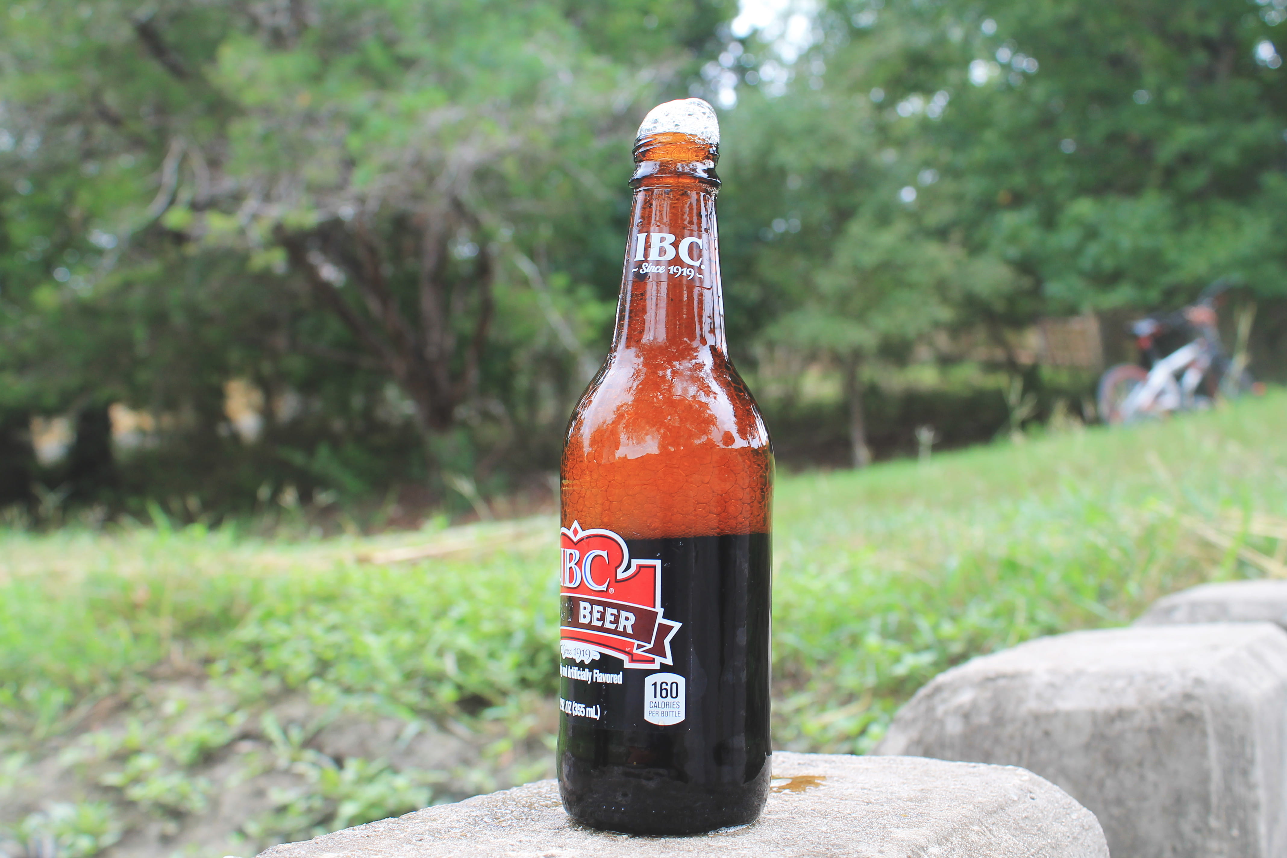 rootbeer, forest, focus on foreground, drink, container, bottle