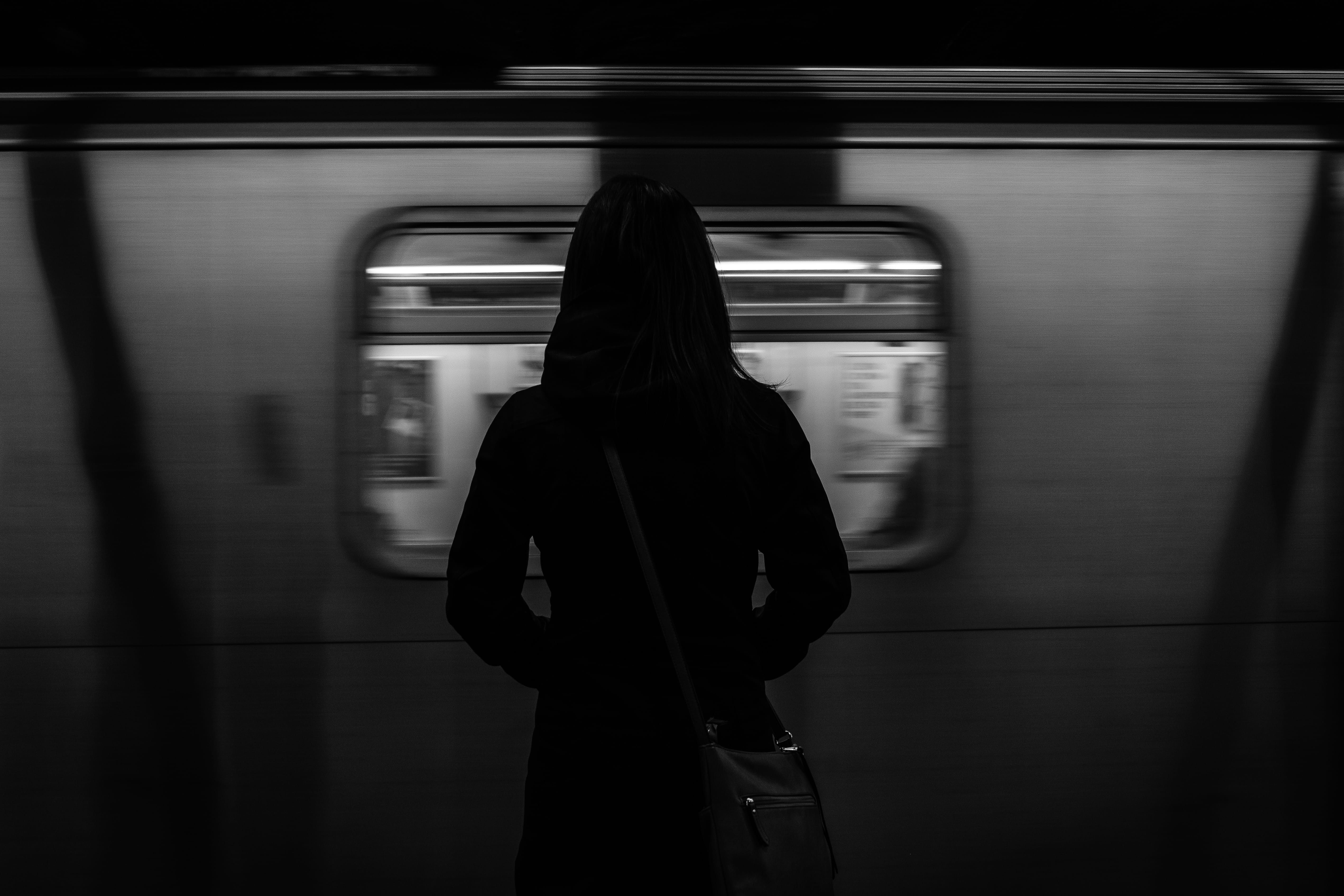 Free Download Hd Wallpaper Grayscale Photography Of Woman Standing Near Running Train Rail