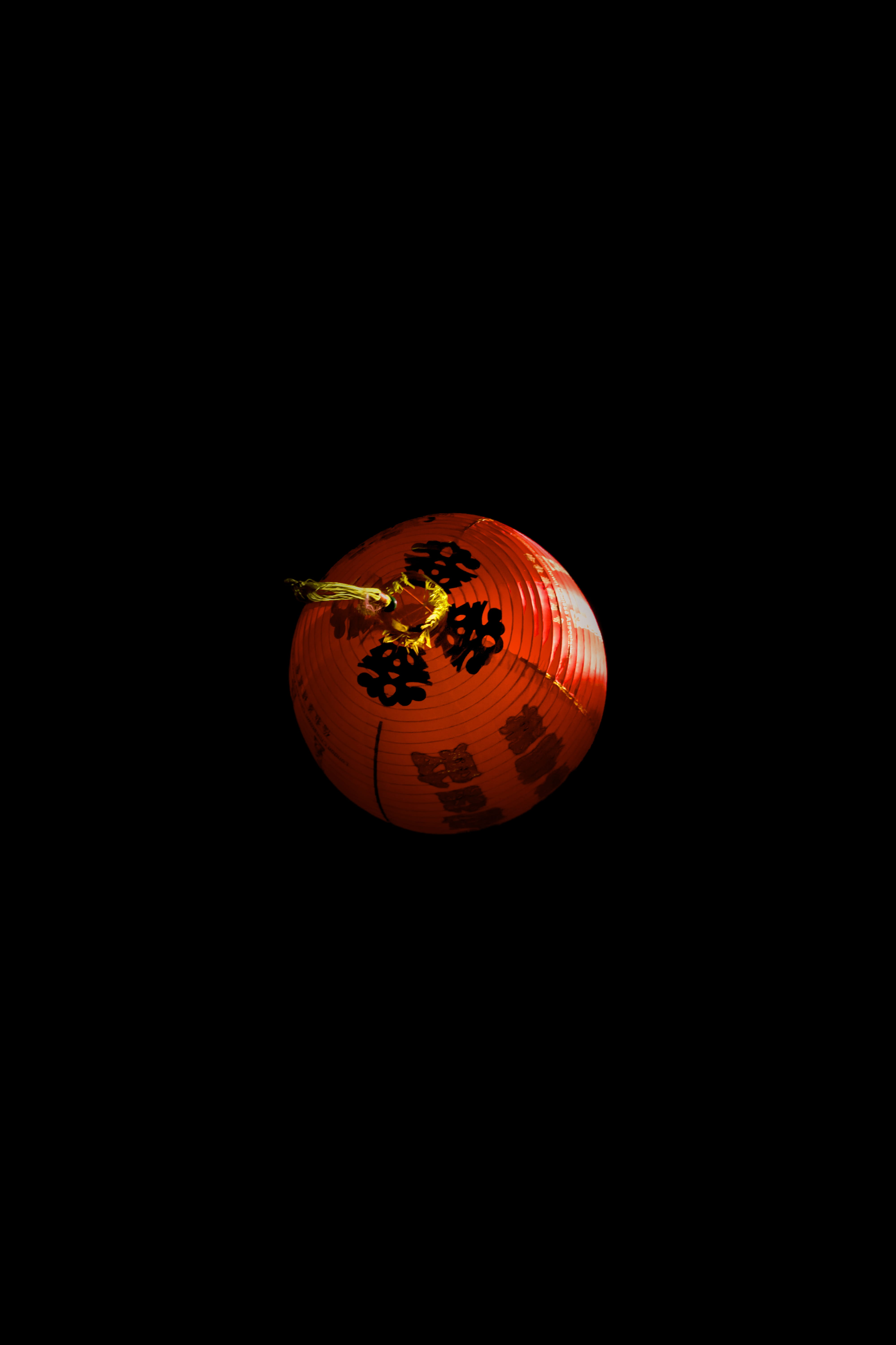 red lantern, copy space, studio shot, black background, single object