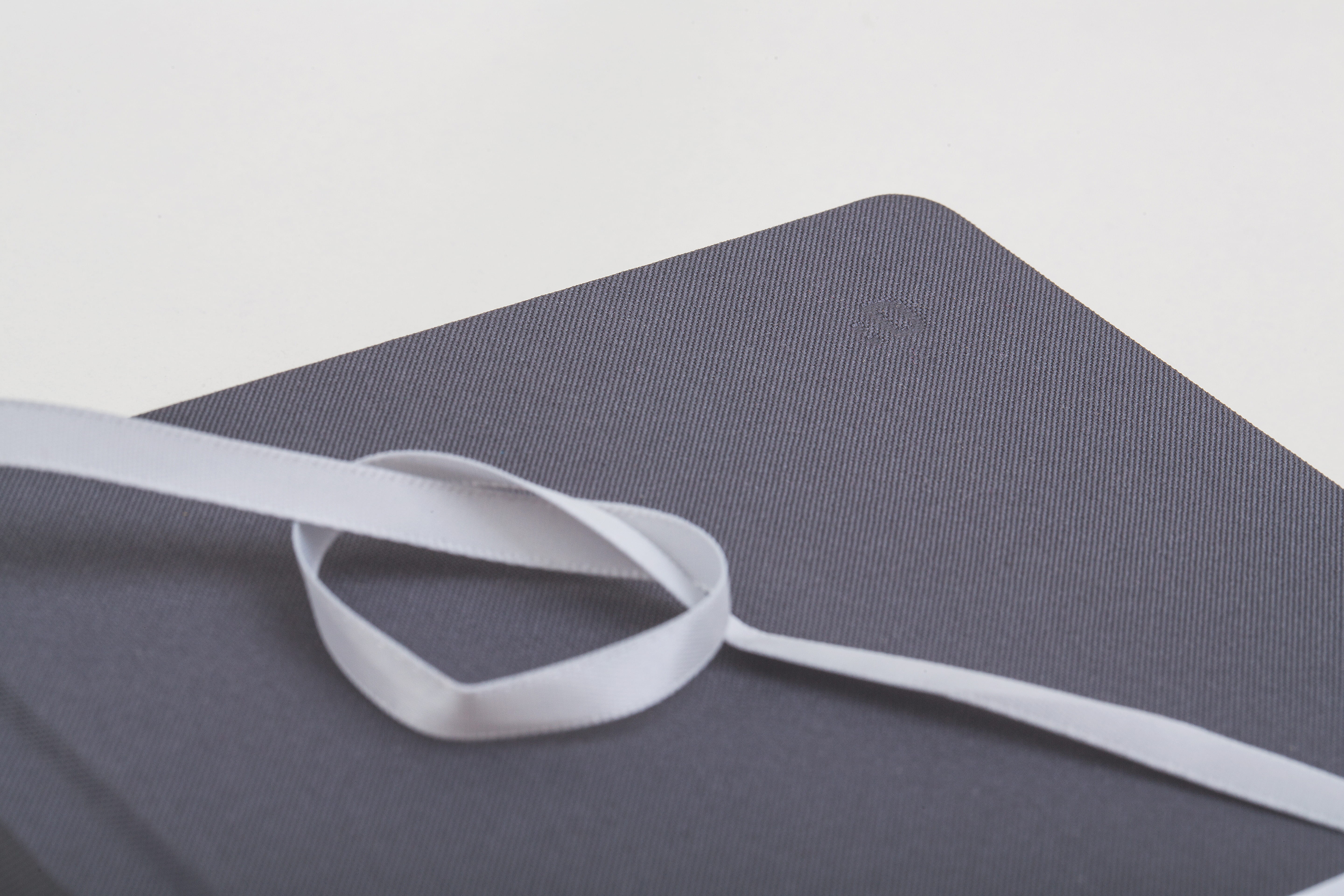 White Ribbon Formed Heart on Brown Rectangular Mat, book, notebook