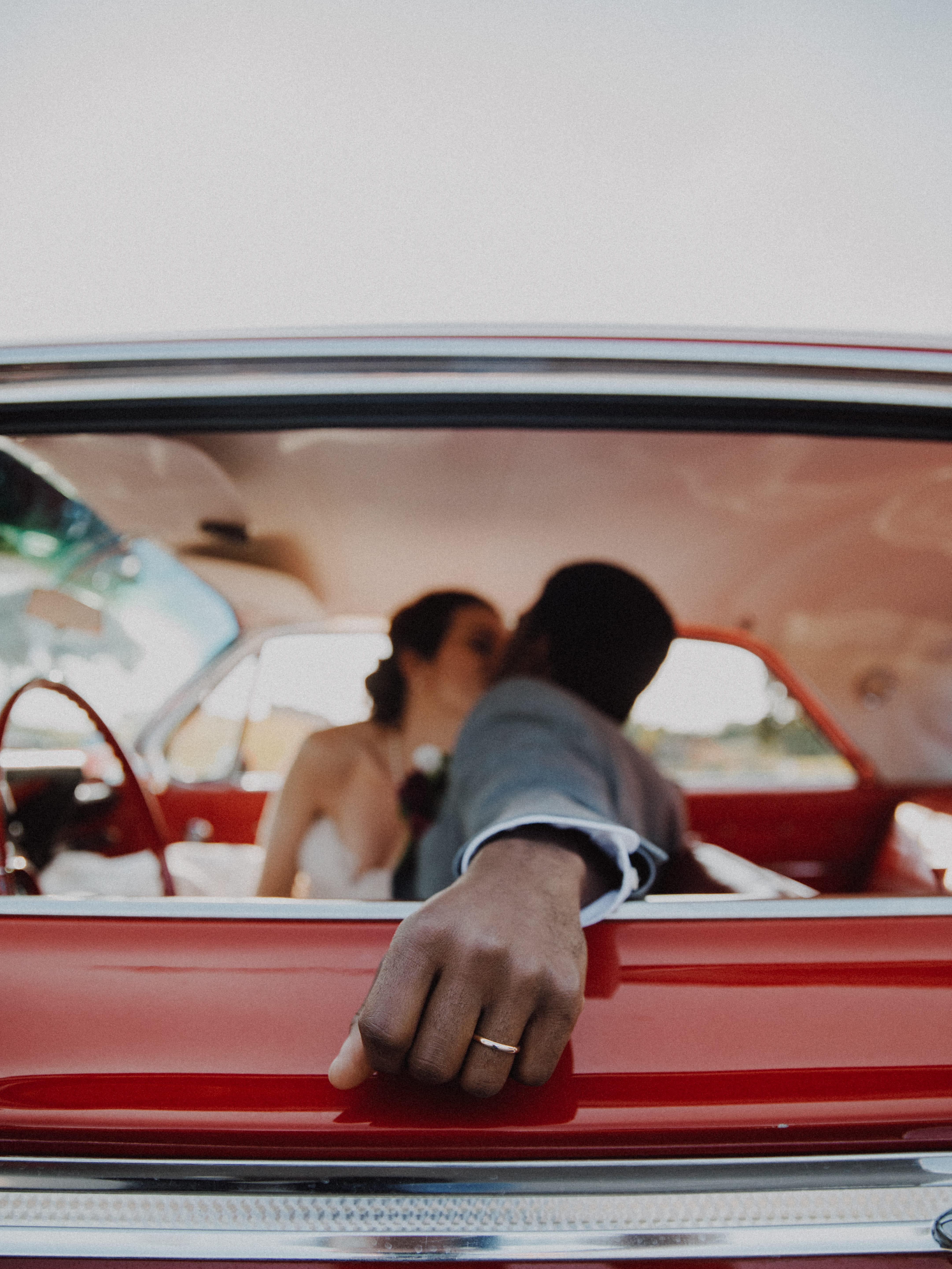 bride and groom kissing inside the car, wedding, marriage, blur