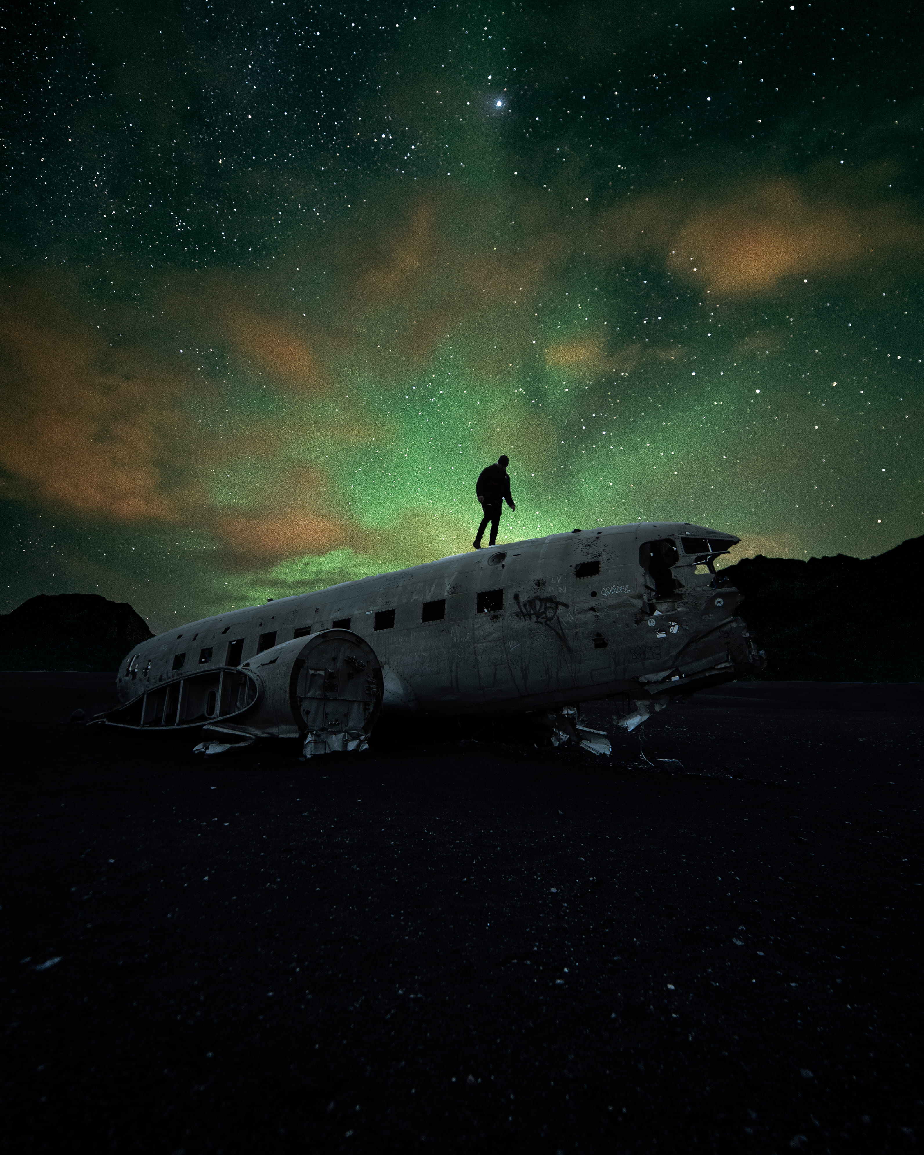 person standing on airplane, sky, northern light, aurora borealis
