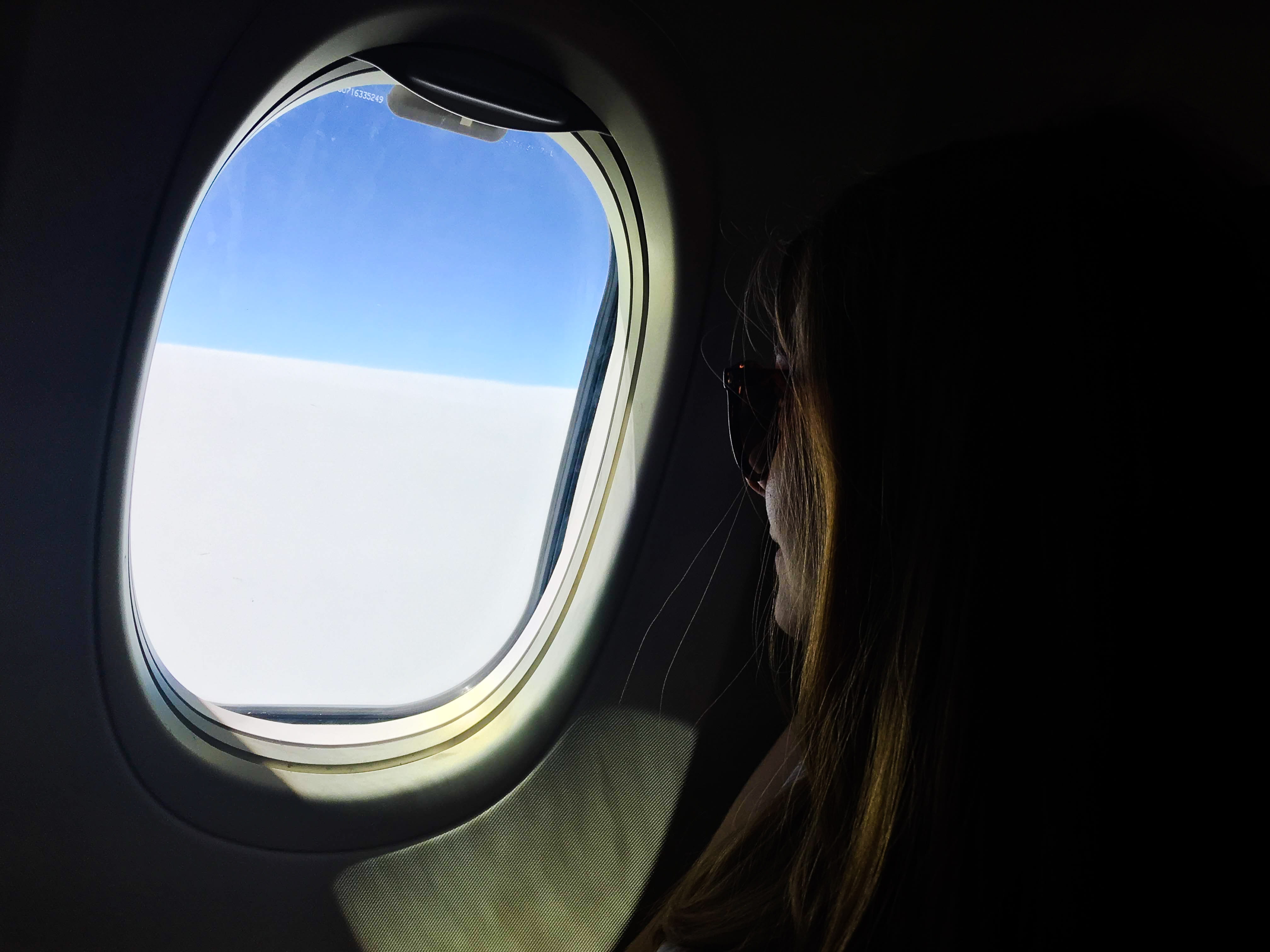 woman looking outside plane window, porthole, person, human, light