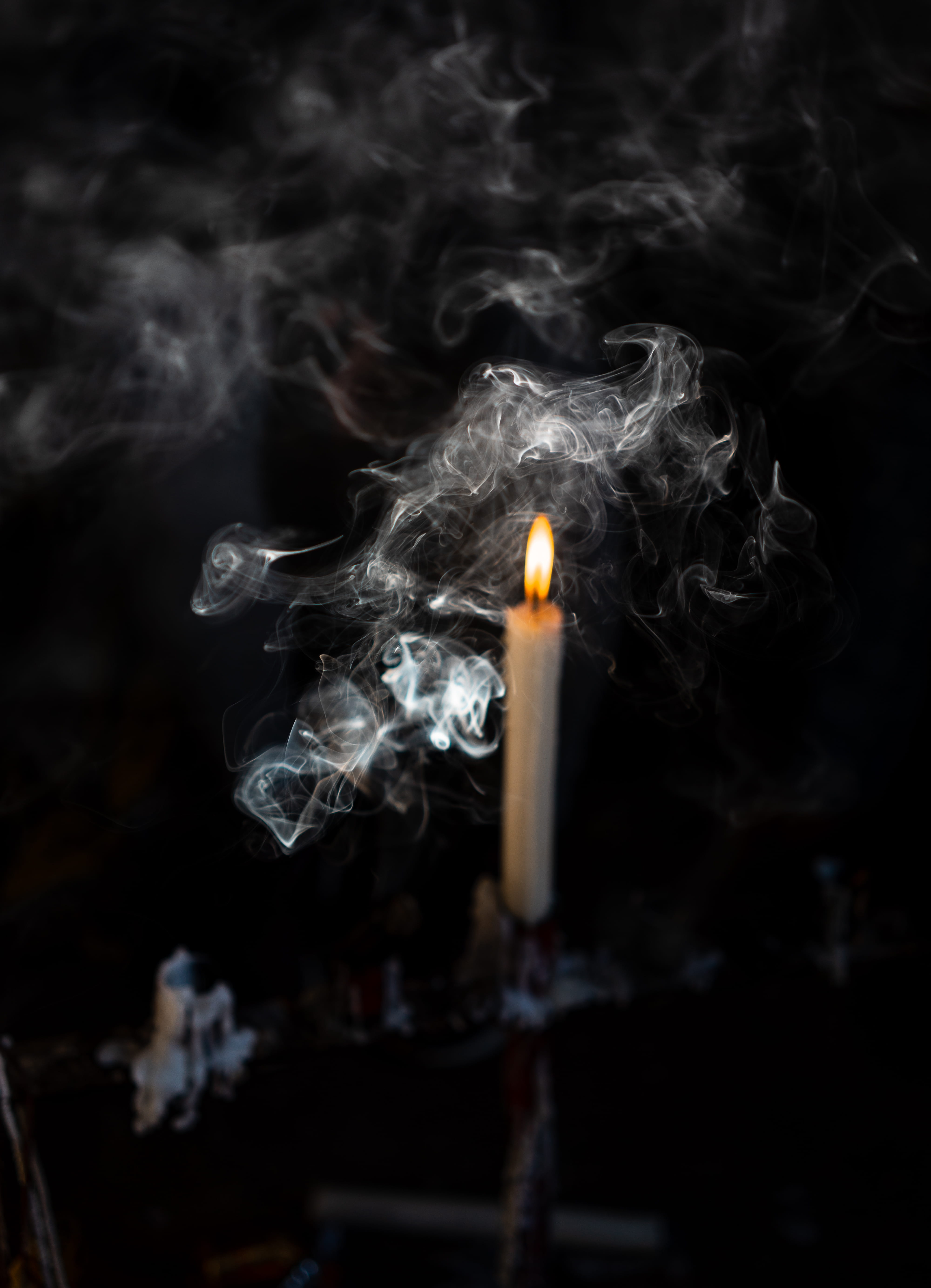 lighted candle on candlestick, smoke - physical structure, heat - temperature
