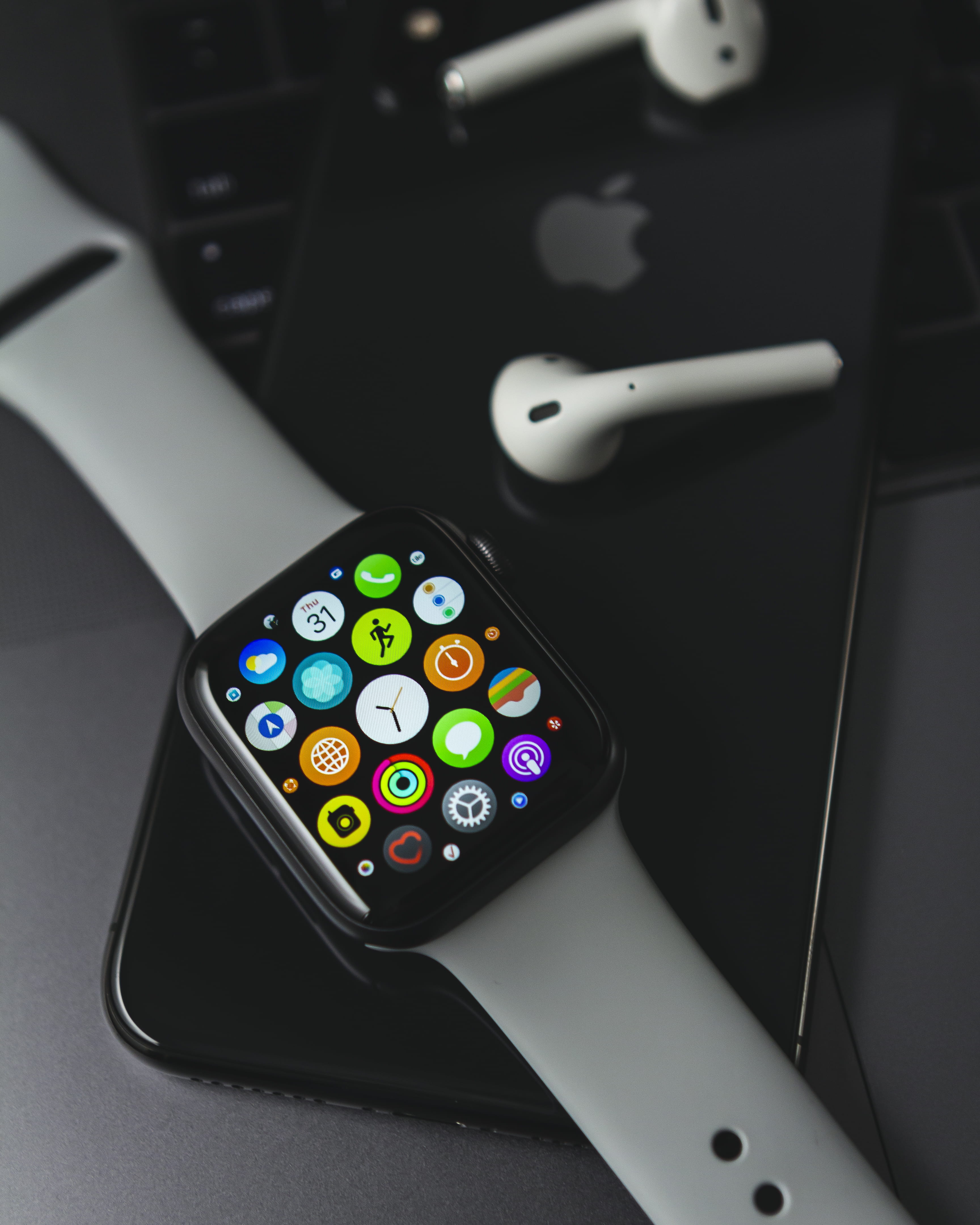 Apple Watch on jet black iPhone 7, close-up, indoors, multi colored