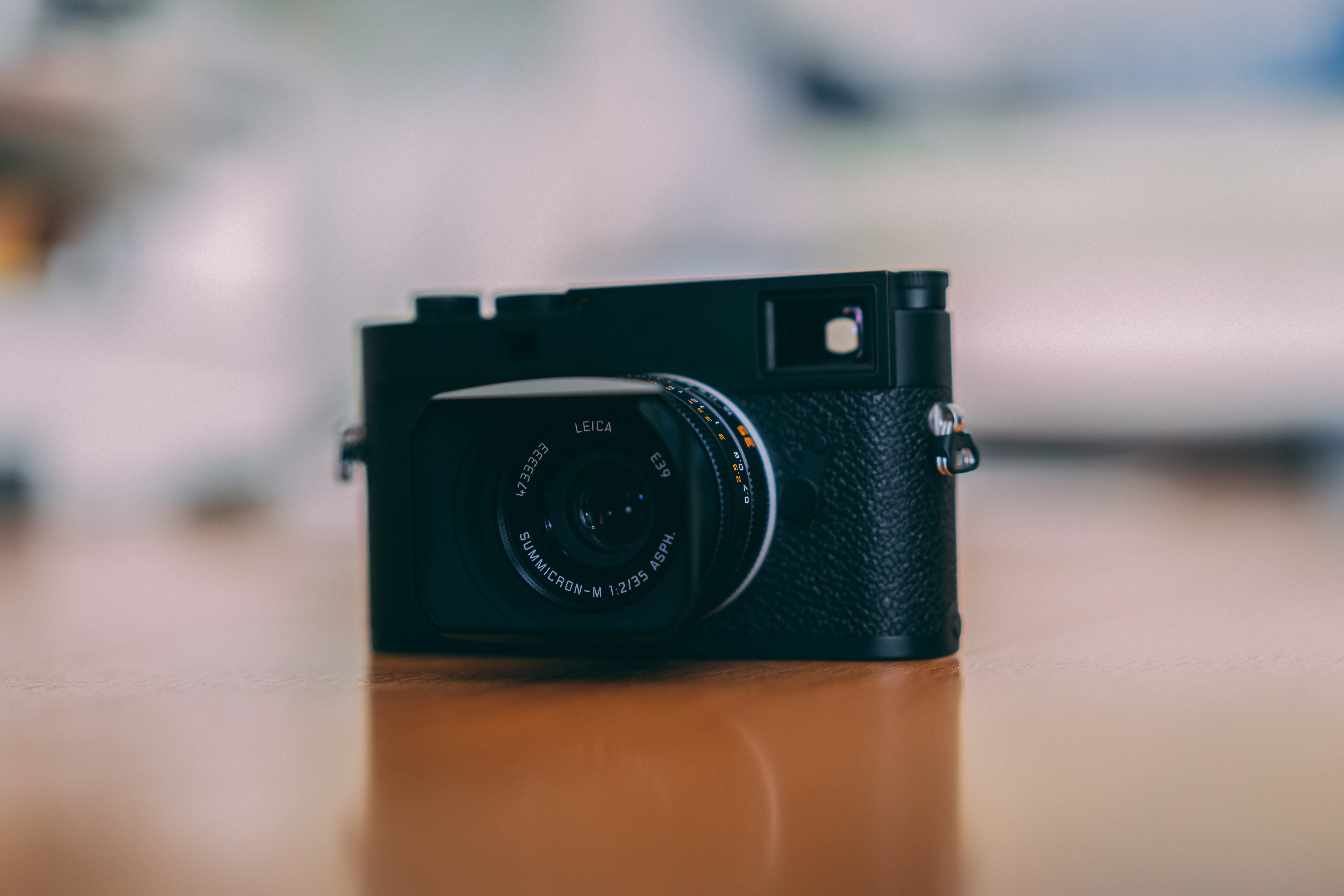 black DSLR camera on table, electronics, digital camera, strap