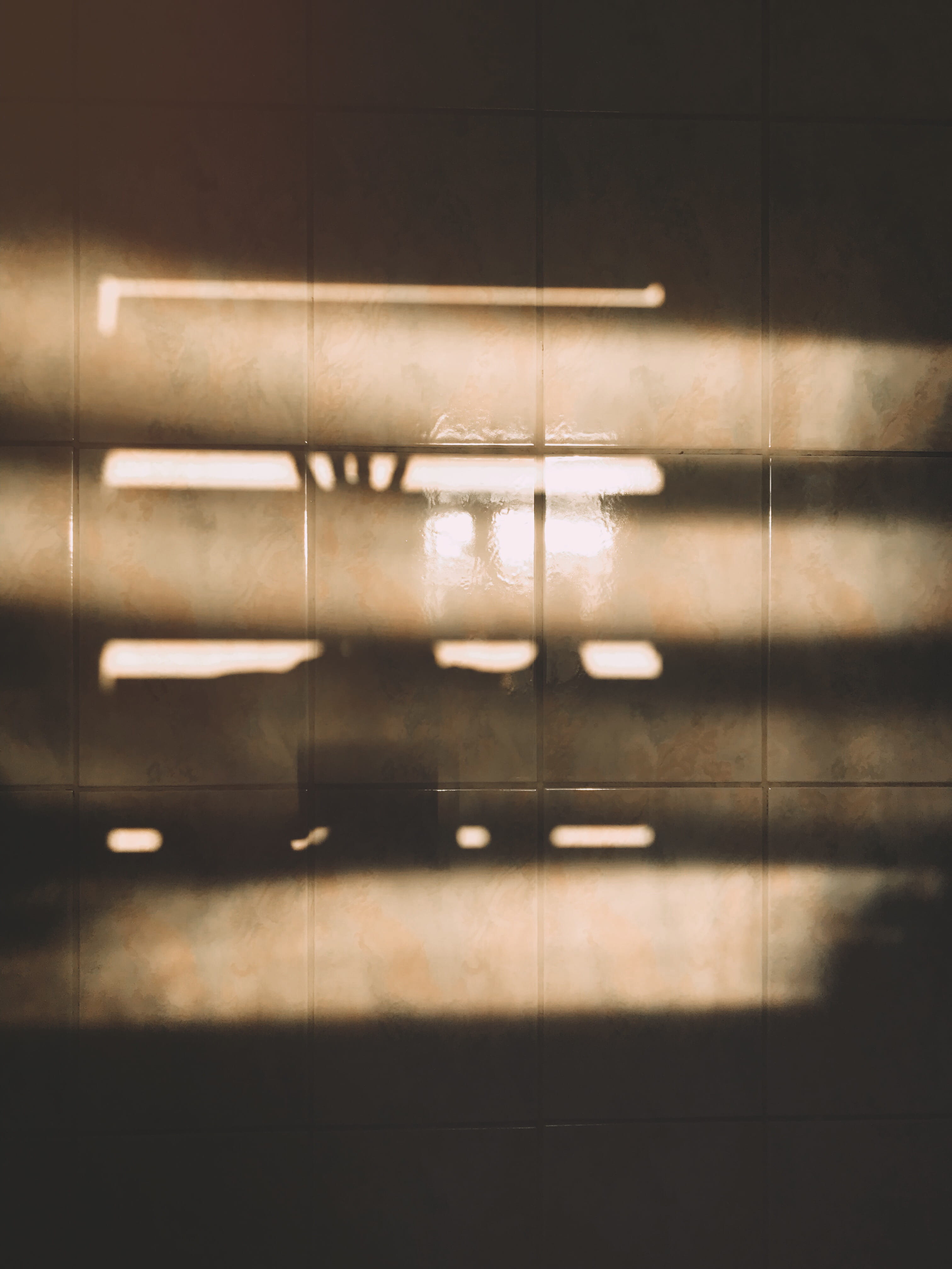 Sunlight Passing Through Window Reflection on Brown Tiled Surface