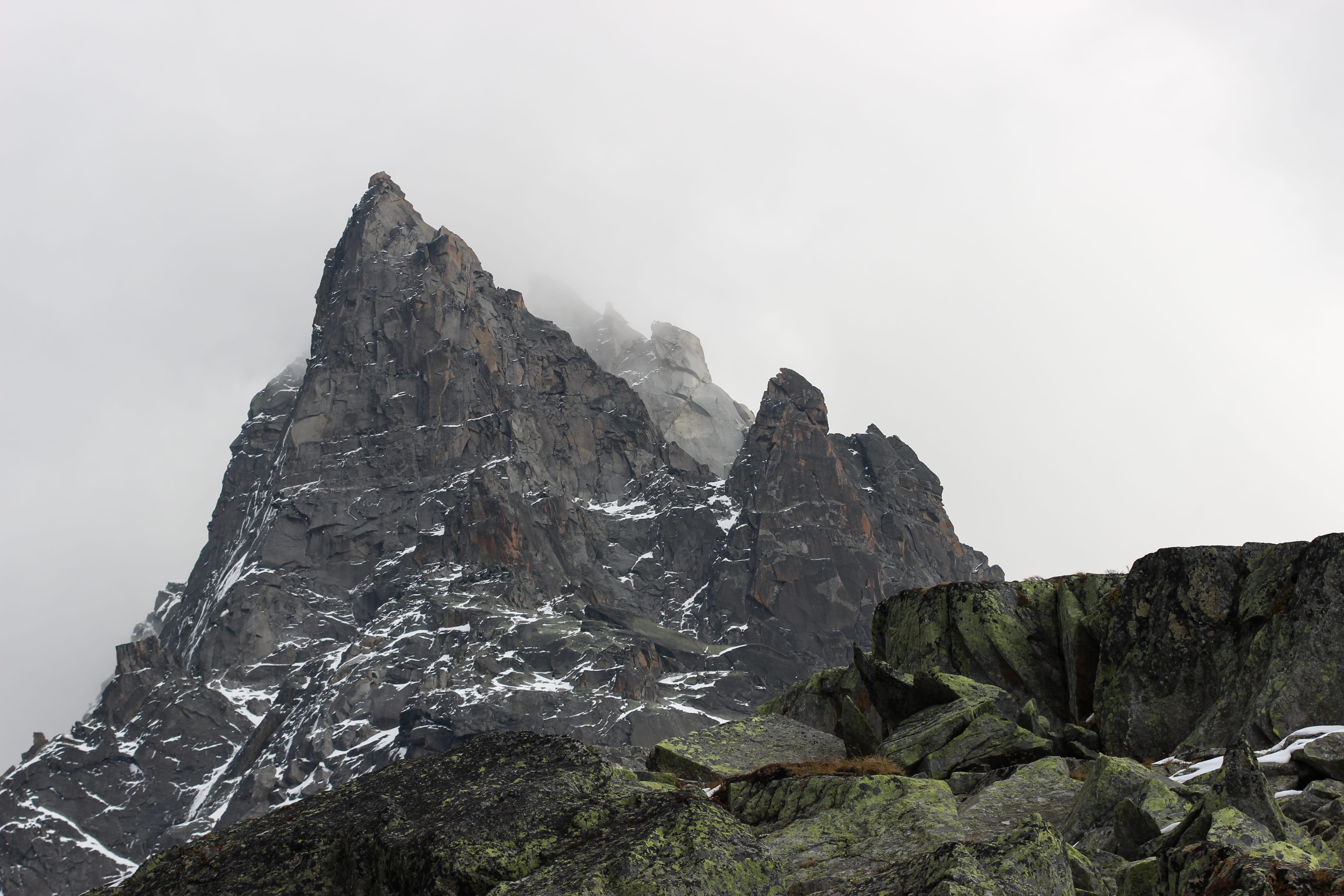 gray rock formation under white clouds, mountain, outdoors, mountain range