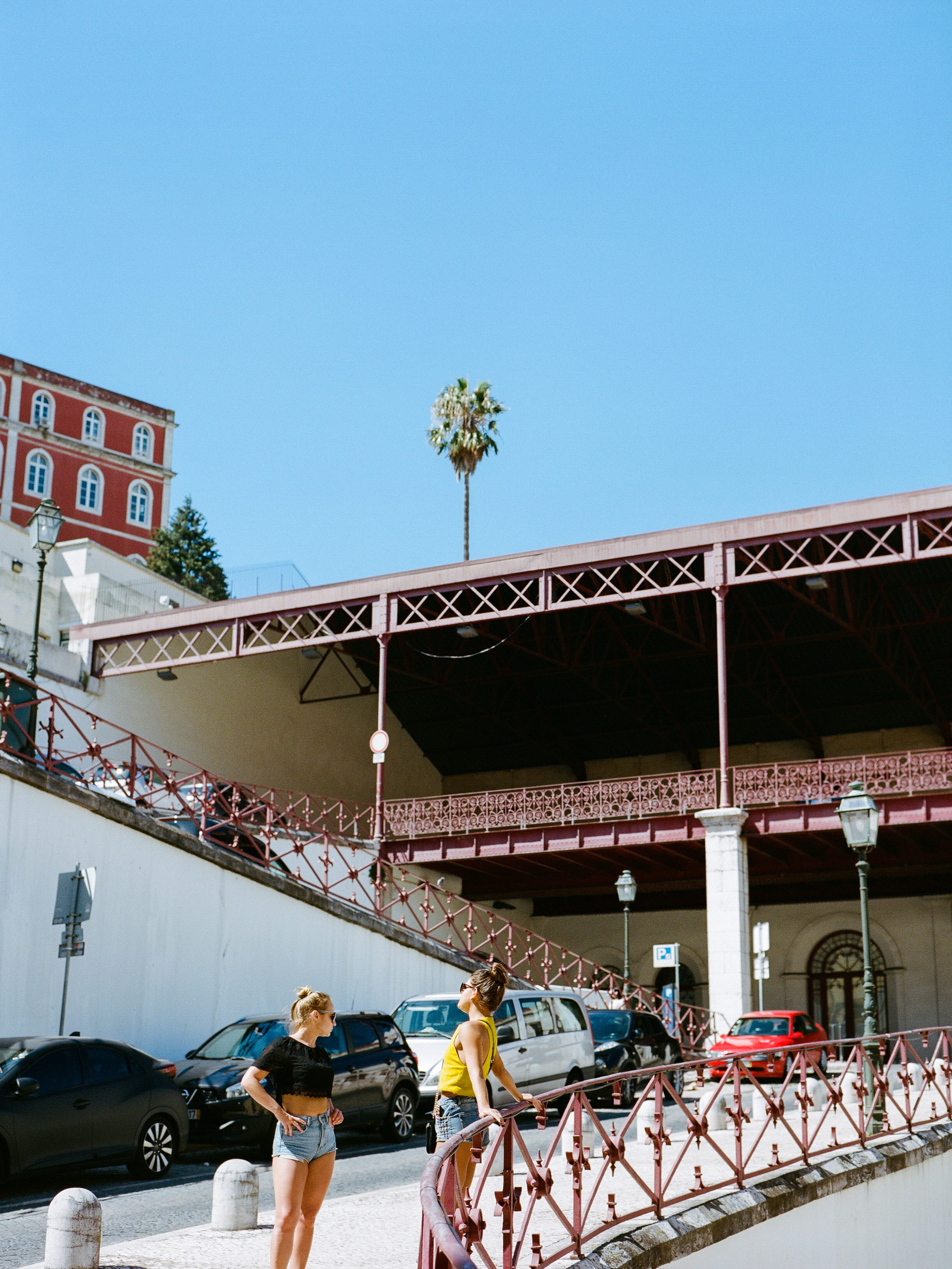 two women standing on sidewalk, architecture, built structure
