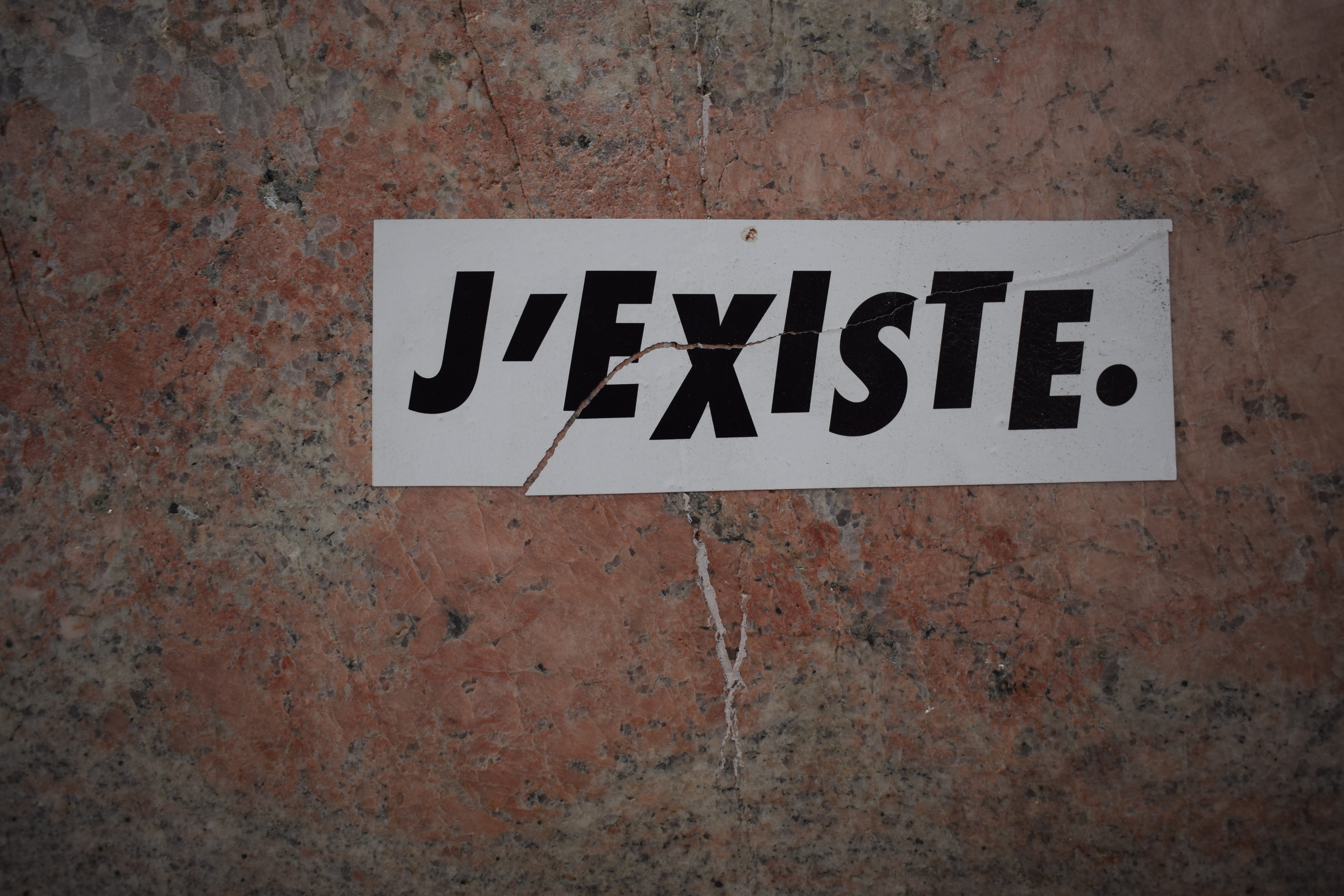 white board with J'existe. text, communication, western script