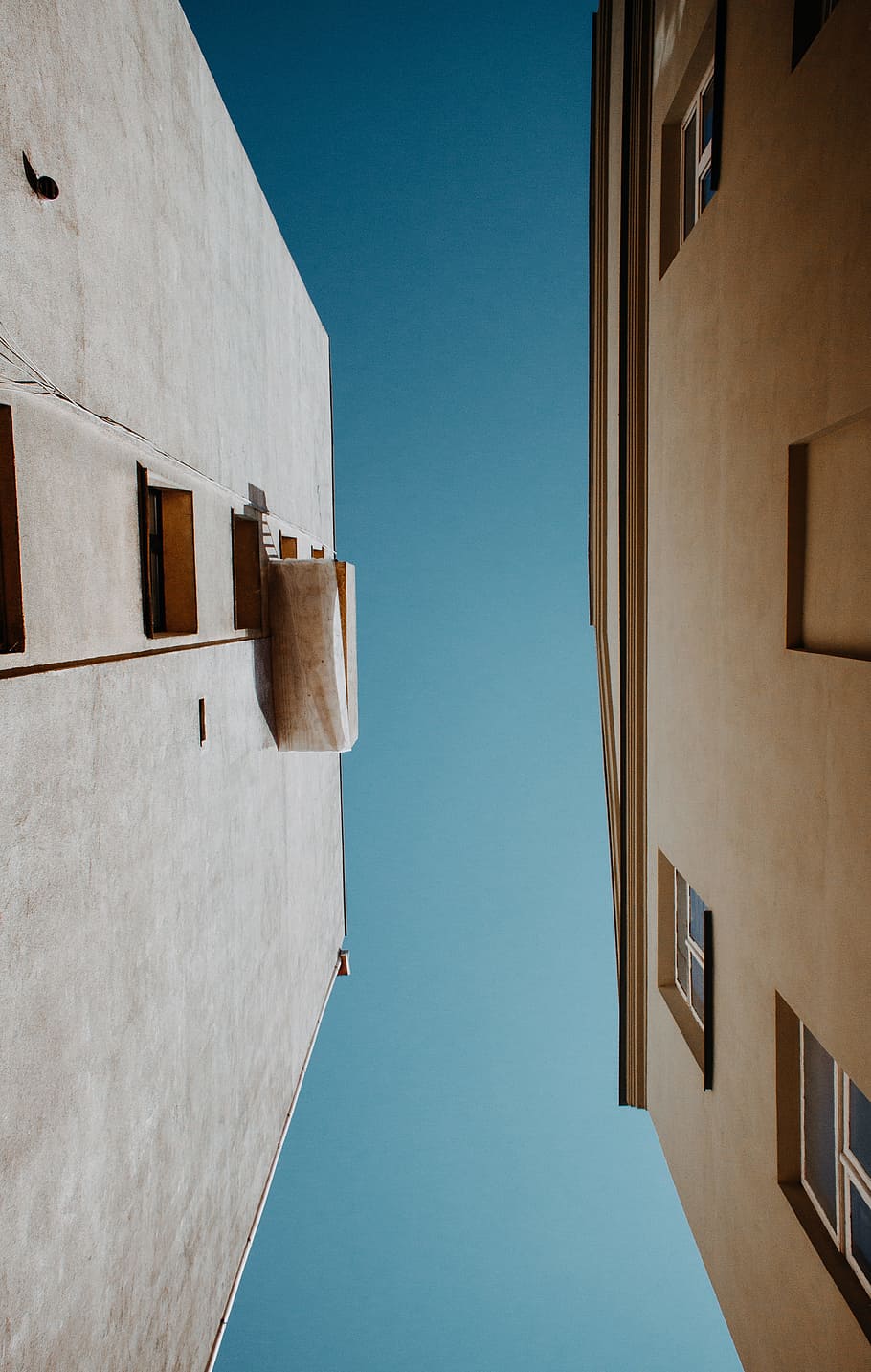 white and beige concrete buildings under gray sky during daytime HD wallpaper