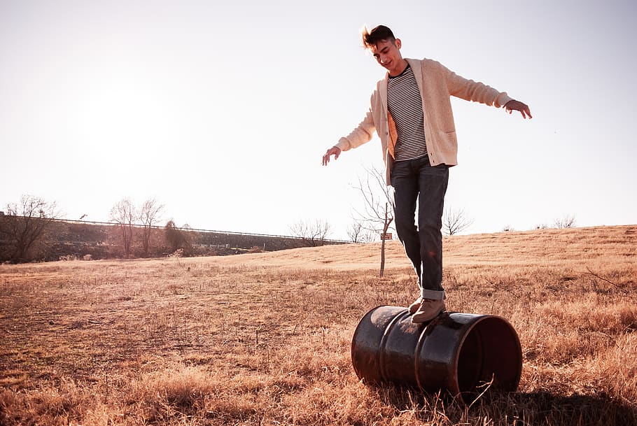 man standing on drum, human, person, soil, outdoors, nature, plant HD wallpaper
