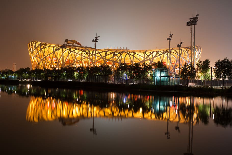 body of water near lighted building during nighttime, china, national stadium